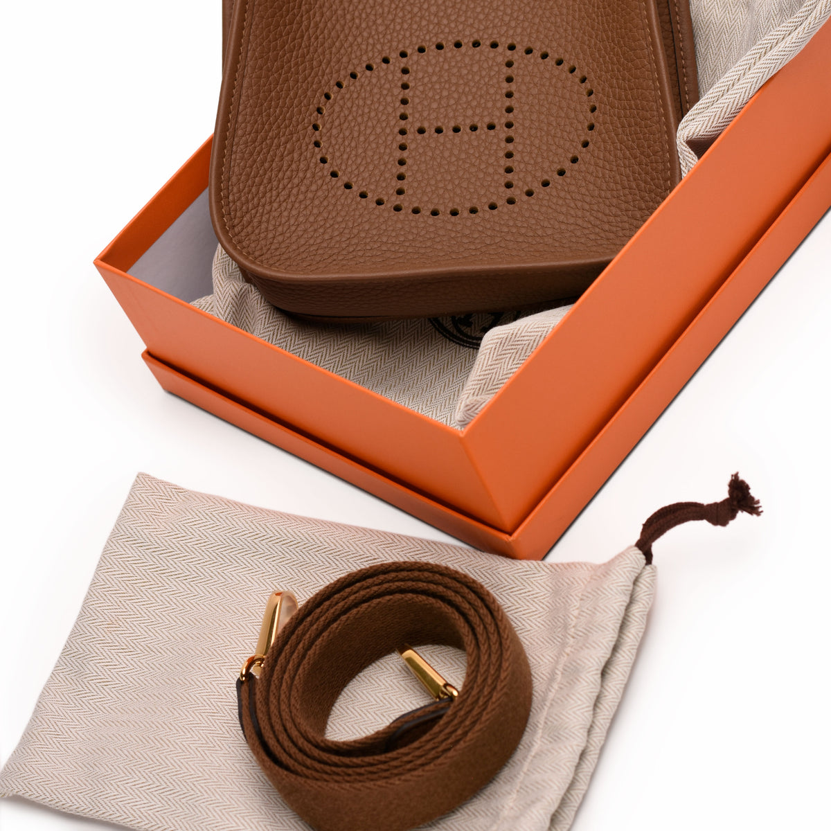 Brown pebbled leather crossbody bag with perforated H logo, curated Pre-loved Luxury by Myluxe in Helsinki.