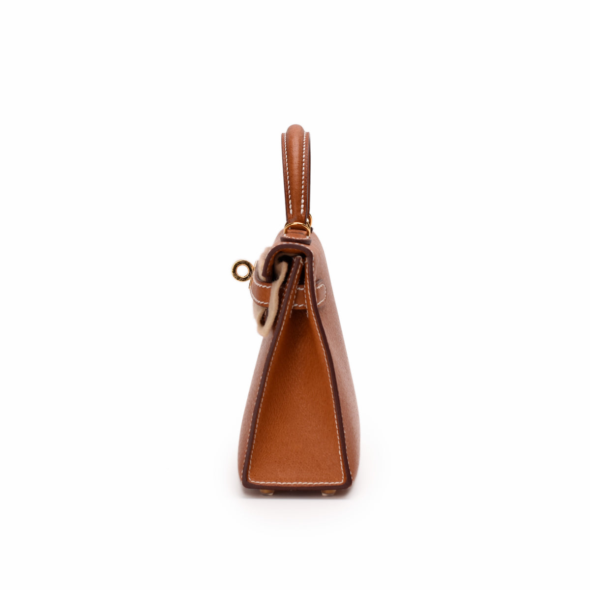 Side view of a tan leather designer handbag with gold-tone hardware, curated Pre-loved Luxury by Myluxe in Helsinki.