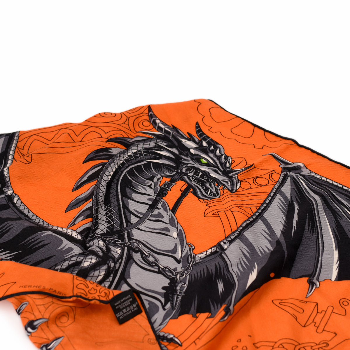 Hermès orange silk scarf featuring a detailed grey dragon illustration. curated Pre-loved Luxury by Myluxe in Helsinki.