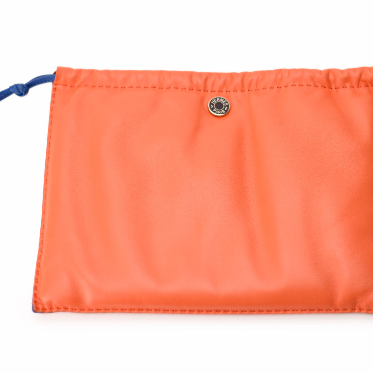 Orange Hermès leather pouch with silver snap button. curated Pre-loved Luxury by Myluxe in Helsinki.
