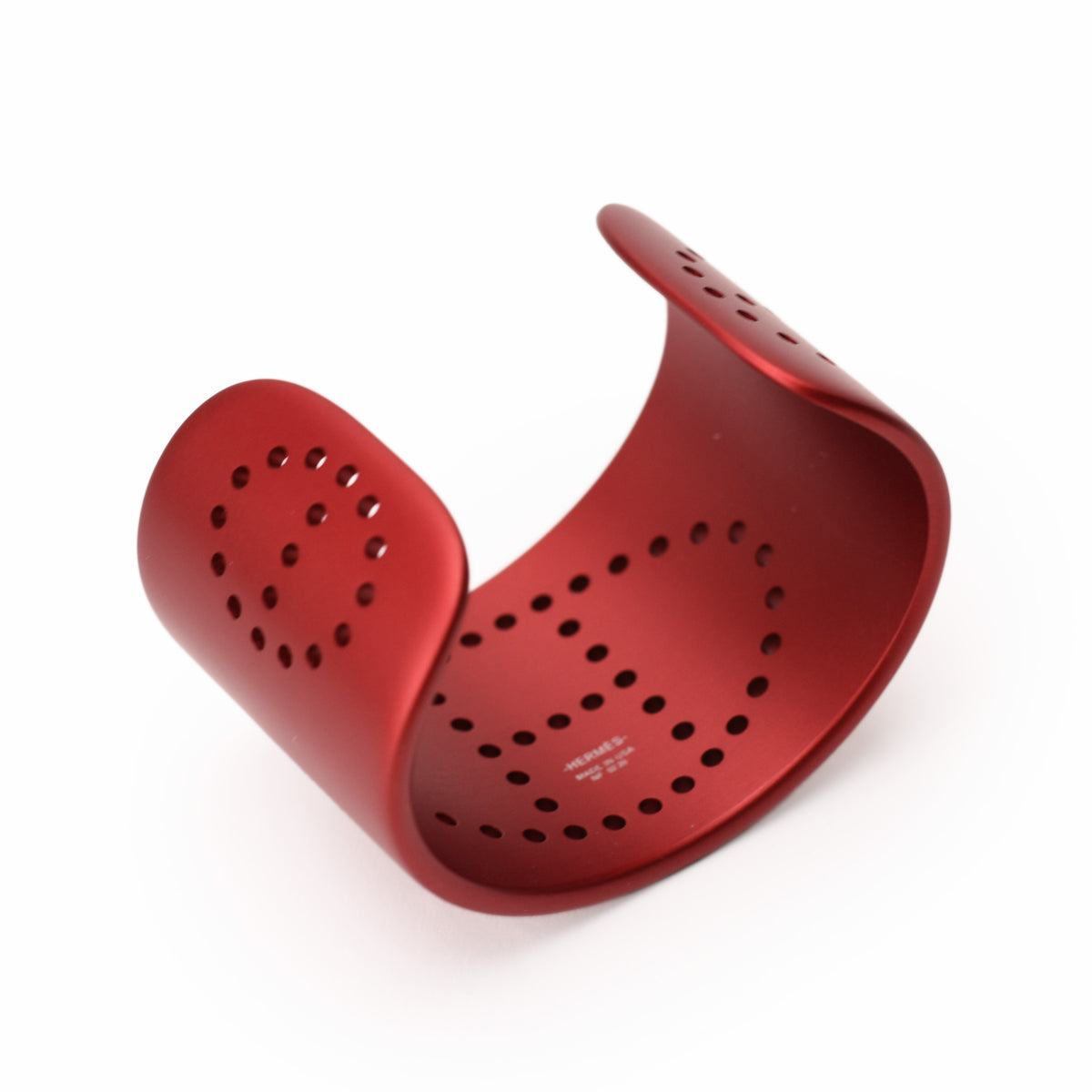 Red matte Hermès metal cuff bracelet with perforated design, curated Pre-loved Luxury by Myluxe in Helsinki.