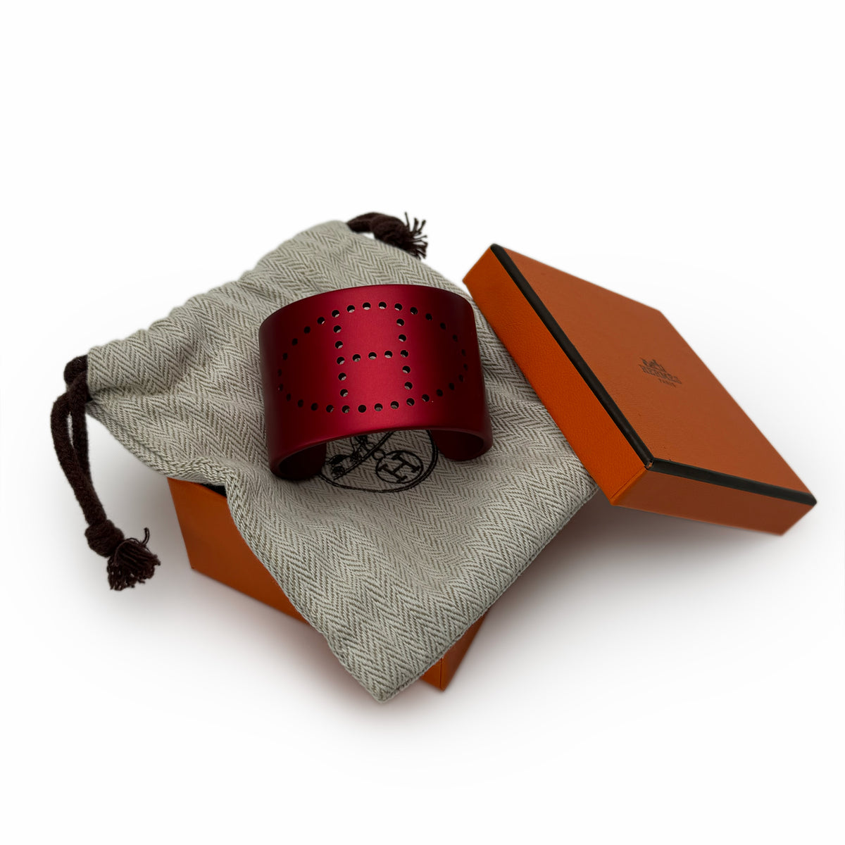 Red perforated leather Hermès cuff bracelet, curated Pre-loved Luxury by Myluxe in Helsinki.