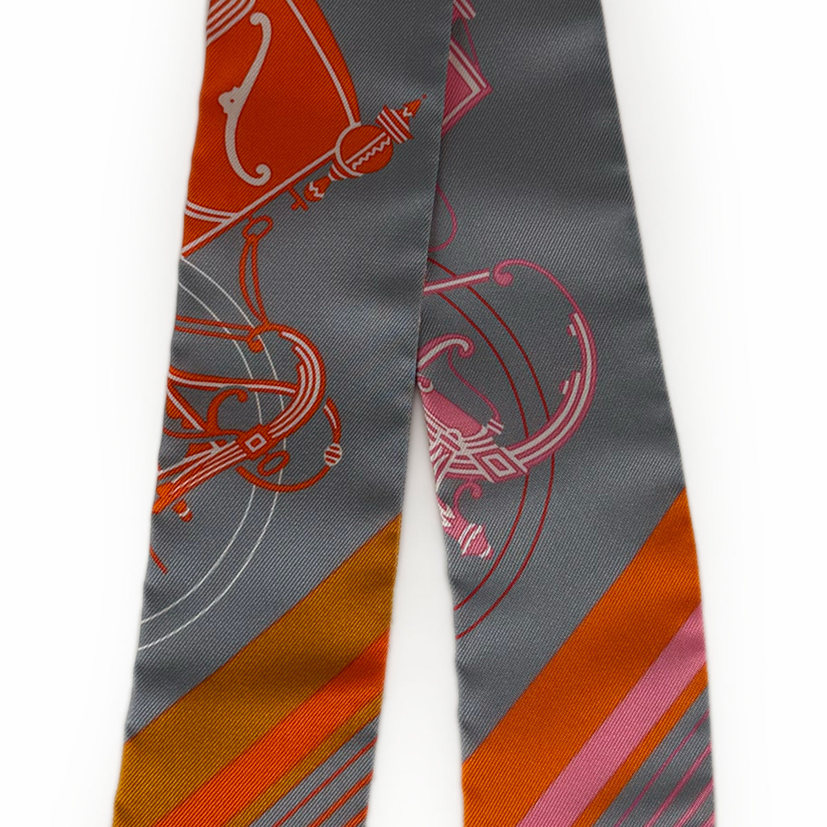 Grey silk scarf with orange and pink equestrian-inspired graphic patterns, curated Pre-loved Luxury by Myluxe in Helsinki.