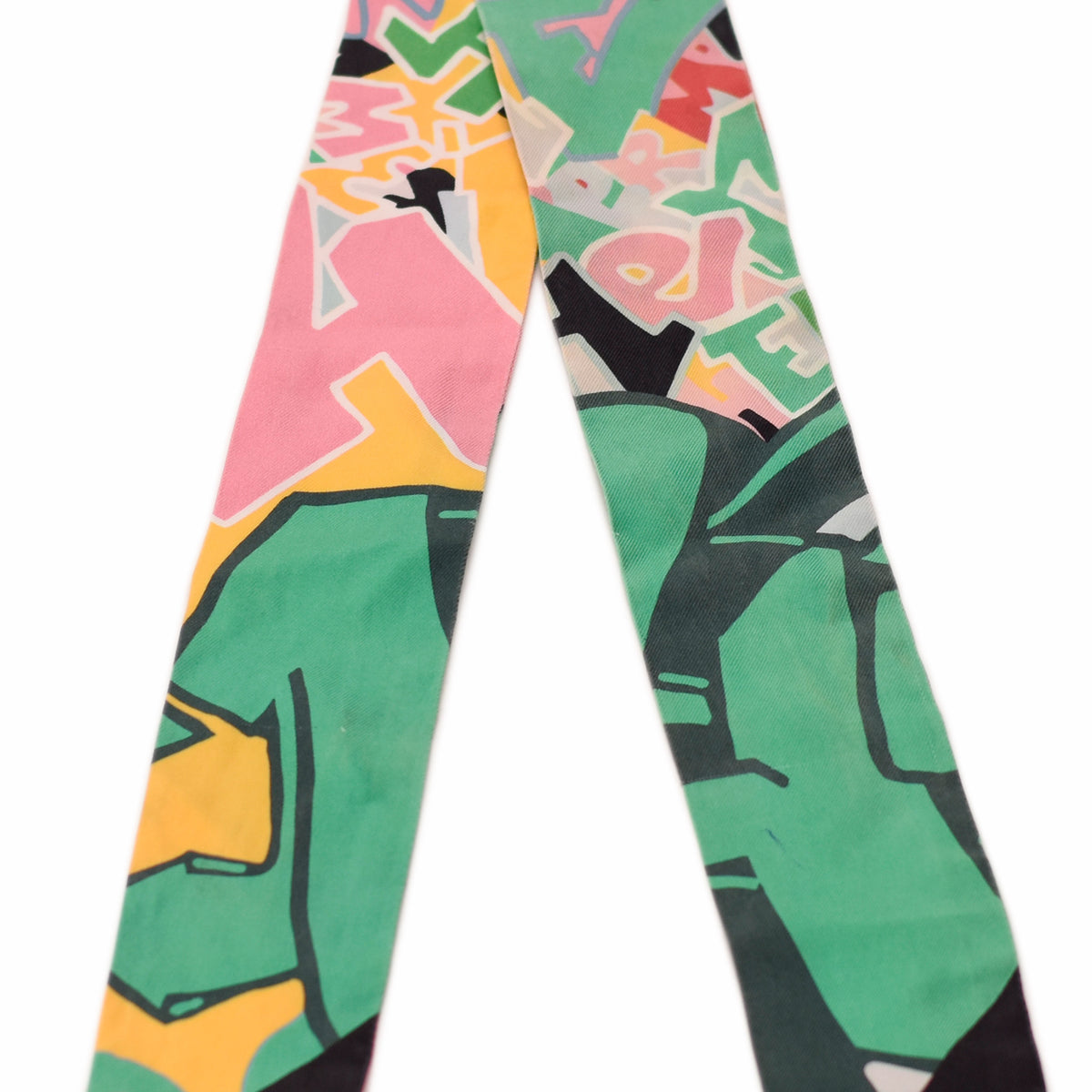 Colorful graffiti print silk scarf in pink, green, and yellow. curated Pre-loved Luxury by Myluxe in Helsinki.