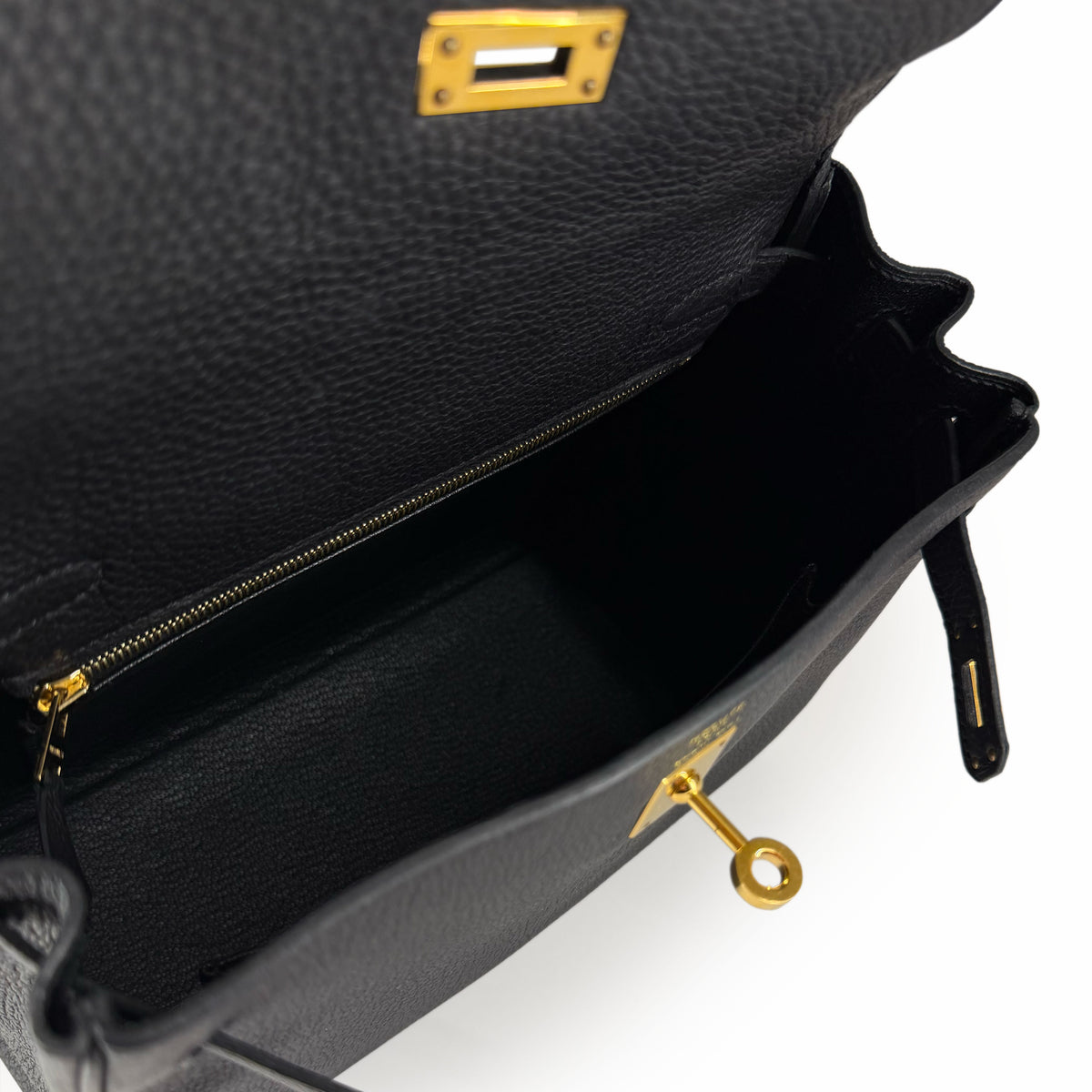 Interior of a black grained leather luxury handbag with gold-tone hardware, curated Pre-loved Luxury by Myluxe in Helsinki.
