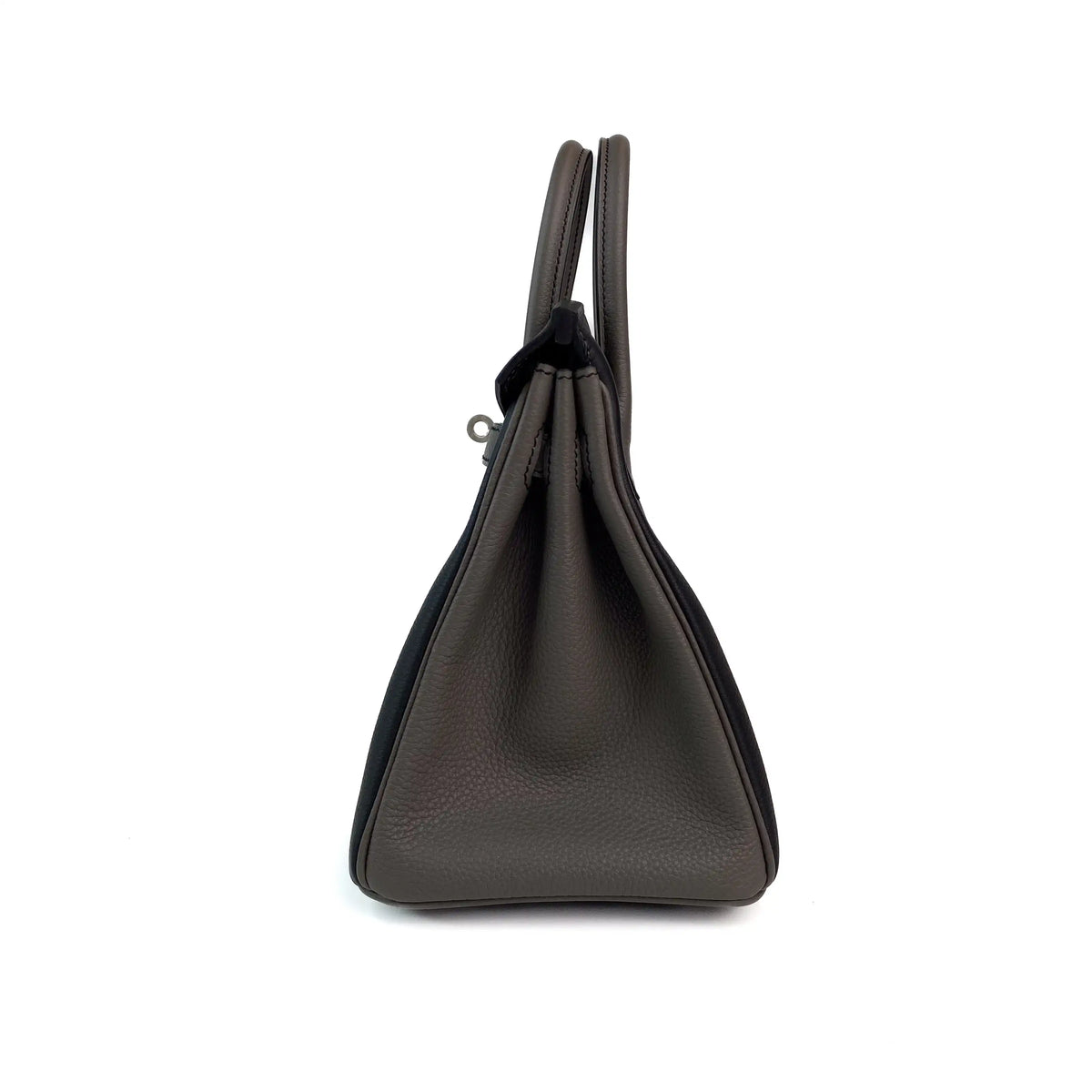 Side view of a dark grey pebbled leather handbag with black suede accents, curated Pre-loved Luxury by Myluxe in Helsinki.