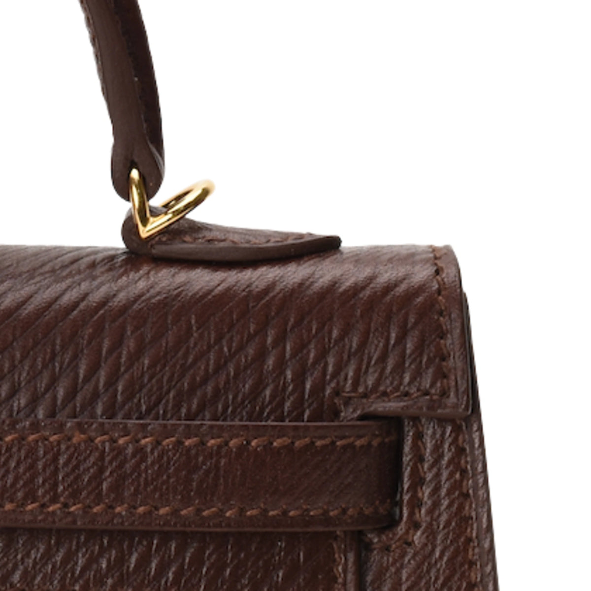 Close-up of Hermès Mini Kelly Sellier in brown Volynka leather with gold hardware. Curated Pre-loved Luxury by Myluxe in Helsinki.