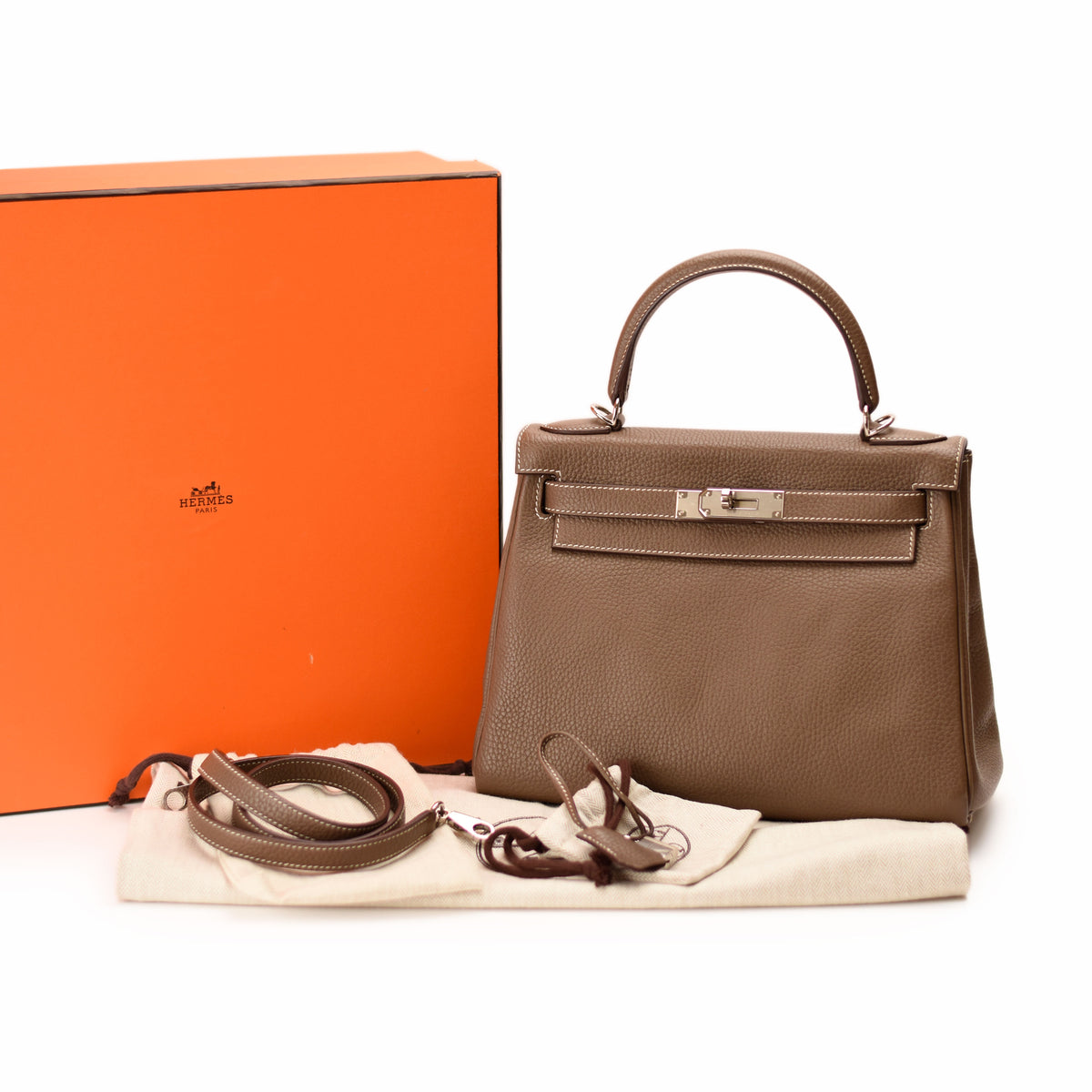Hermès brown leather handbag with matching strap and orange box. curated Pre-loved Luxury by Myluxe in Helsinki.