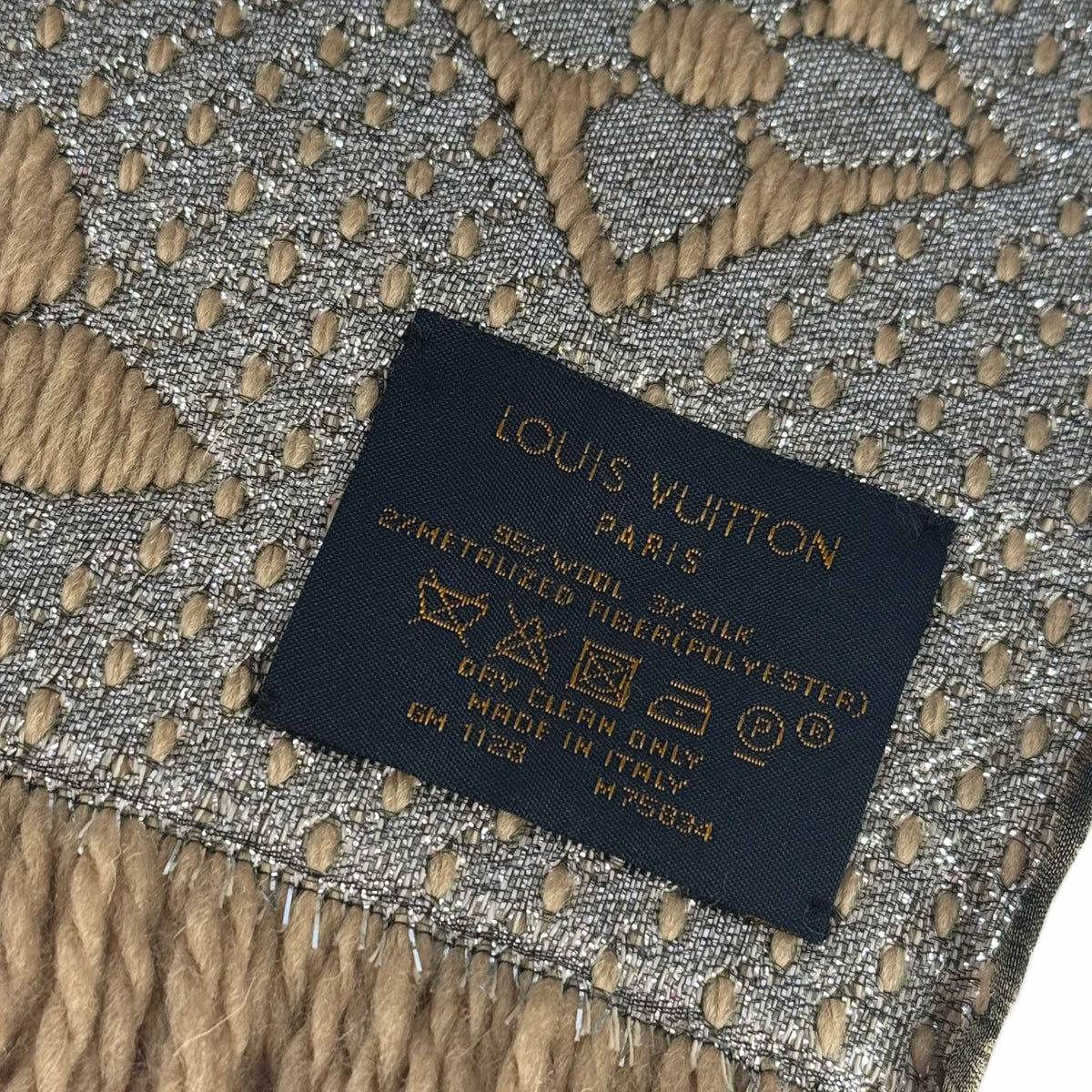 Louis Vuitton Paris label on gold and silver metallic woven fabric, curated Pre-loved Luxury by Myluxe in Helsinki.