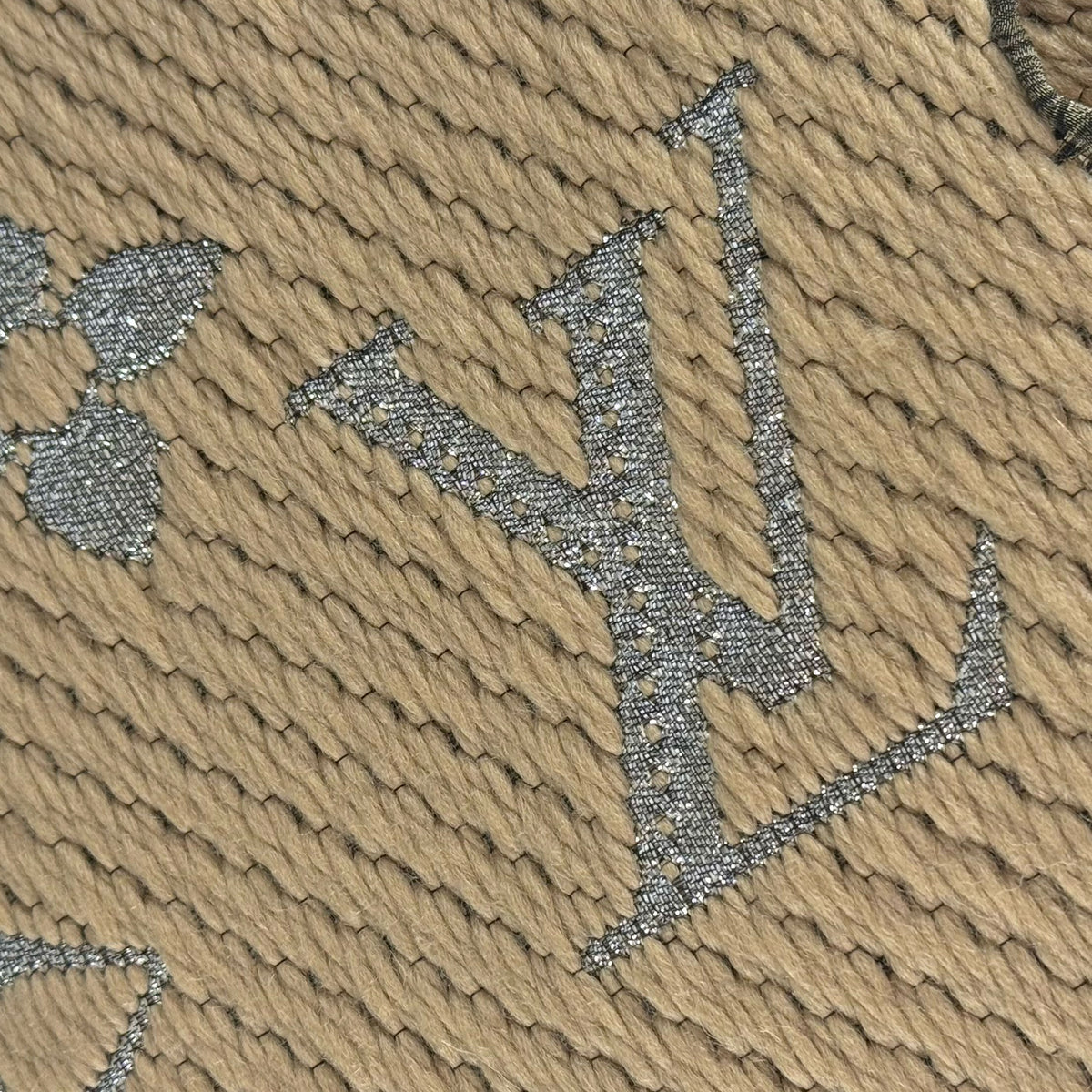 Silver glittery Louis Vuitton monogram pattern on beige textured fabric, curated Pre-loved Luxury by Myluxe in Helsinki.