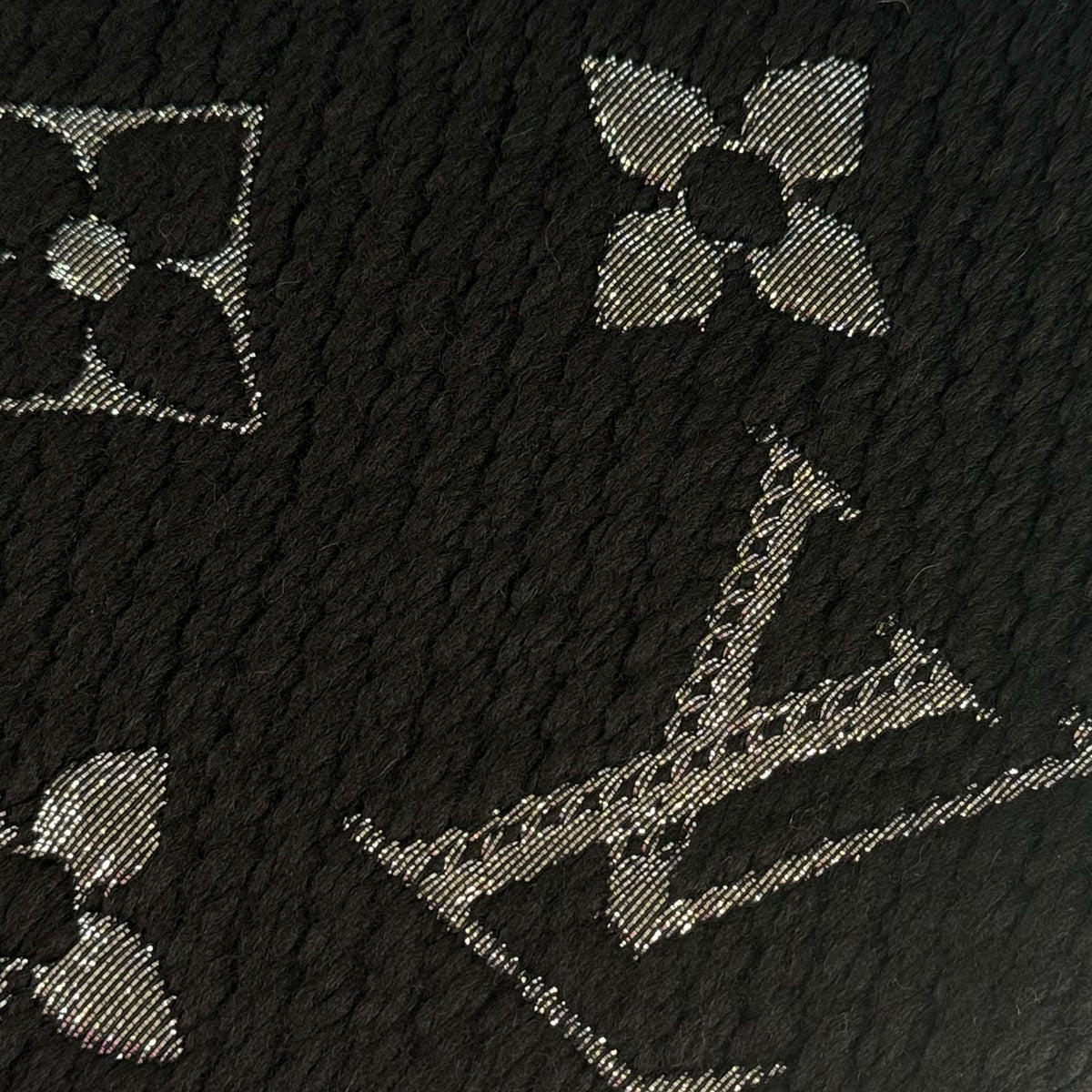 Black textured monogram fabric with silver metallic Louis Vuitton pattern, curated Pre-loved Luxury by Myluxe in Helsinki.