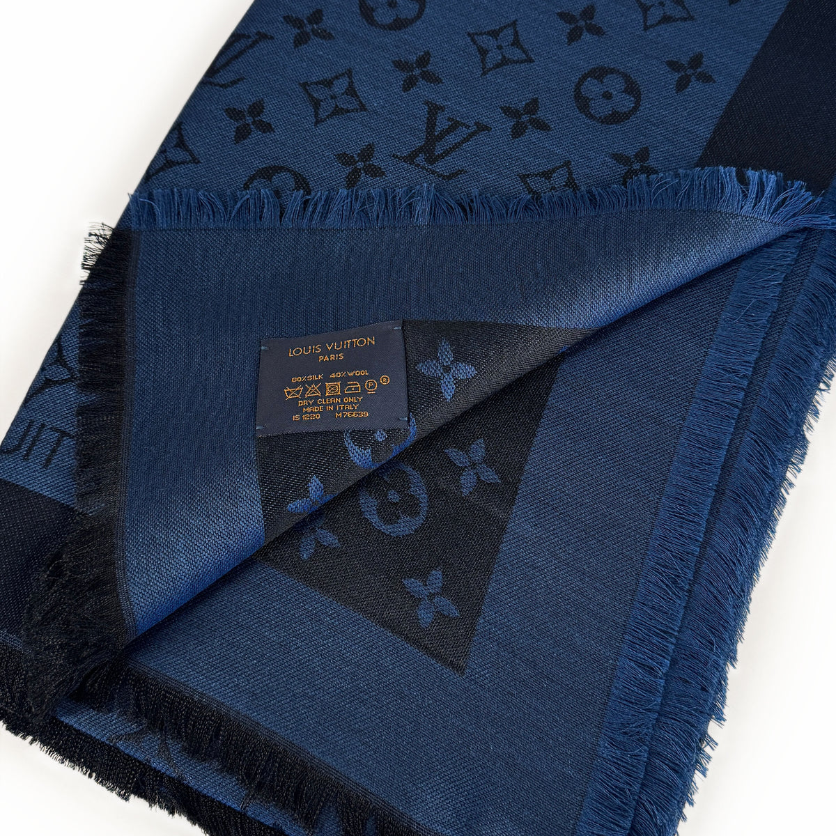 Navy blue Louis Vuitton silk and wool monogram scarf with fringed edges, curated Pre-loved Luxury by Myluxe in Helsinki.