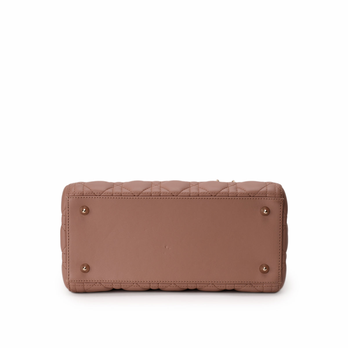 Bottom view of a dusty rose quilted leather Chanel handbag, curated Pre-loved Luxury by Myluxe in Helsinki.