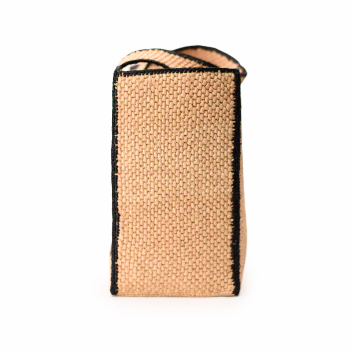 Tan woven textured designer handbag with black trim, curated Pre-loved Luxury by Myluxe in Helsinki.