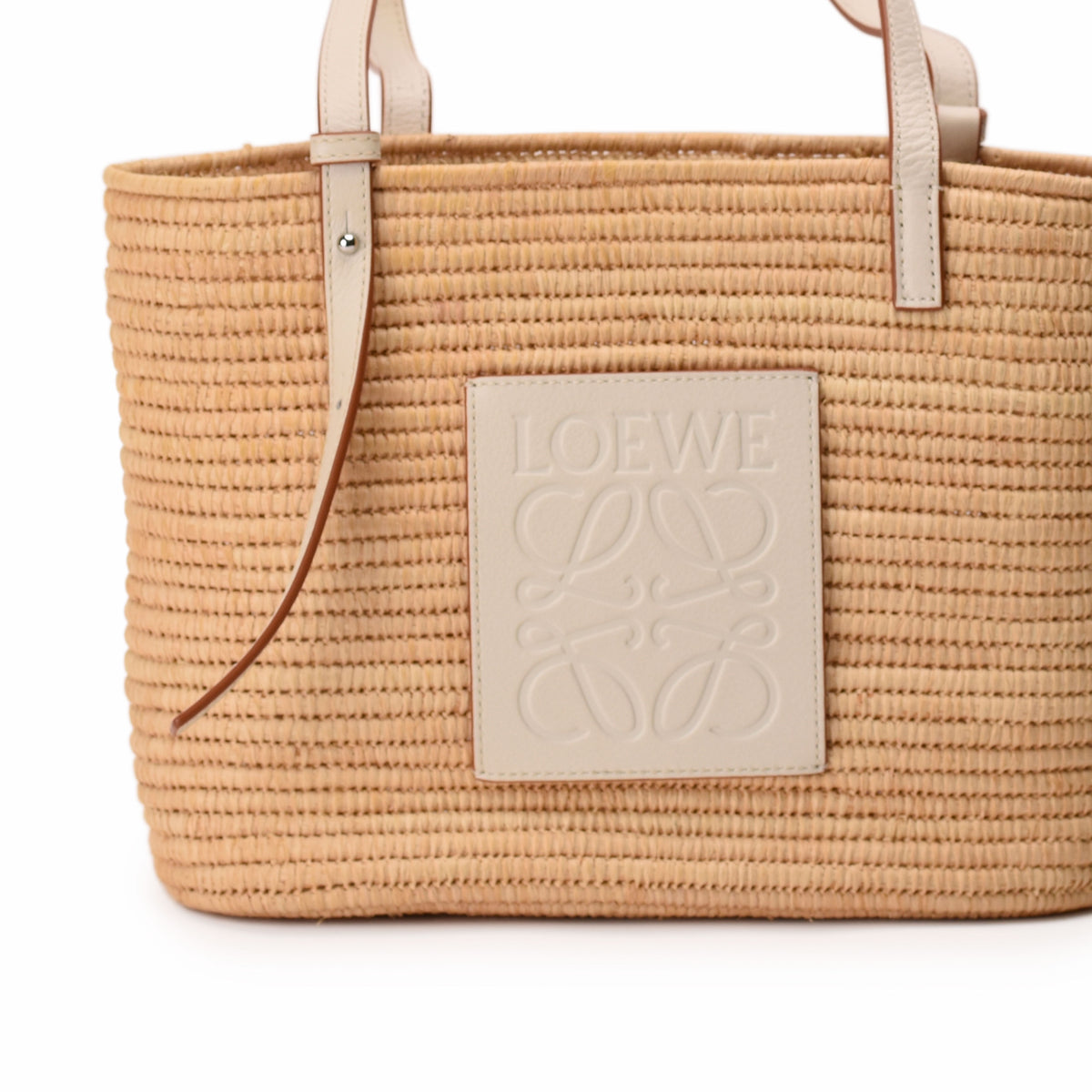 Beige woven straw Loewe tote bag with embossed logo patch, curated Pre-loved Luxury by Myluxe in Helsinki.