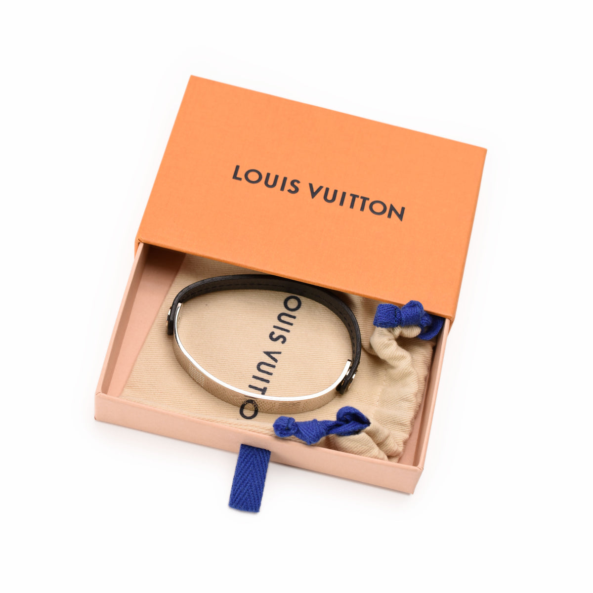 Louis Vuitton gold-tone metal bangle in an orange signature box, curated Pre-loved Luxury by Myluxe in Helsinki.
