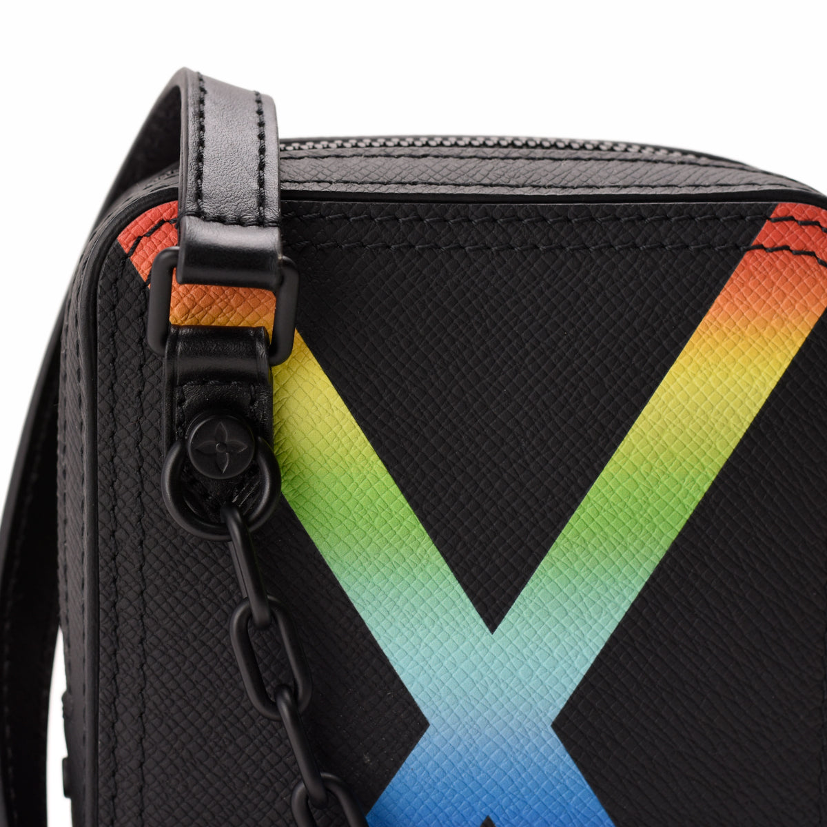 Black textured leather crossbody bag with a vibrant rainbow X design, curated Pre-loved Luxury by Myluxe in Helsinki.