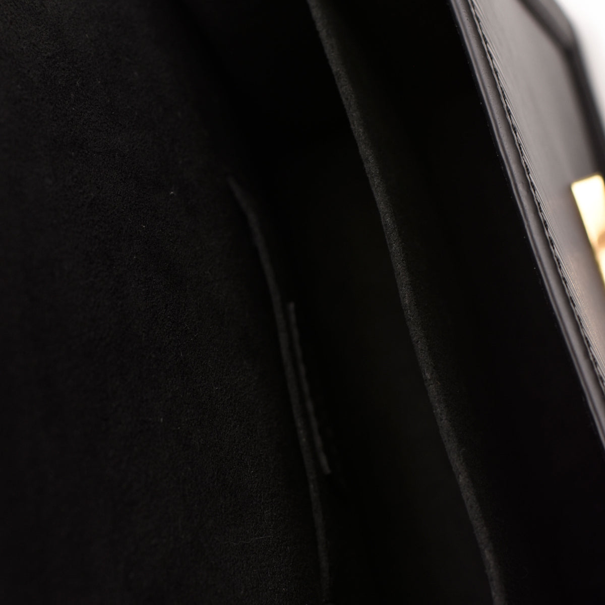 Black suede interior lining of a luxury designer handbag, curated Pre-loved Luxury by Myluxe in Helsinki.