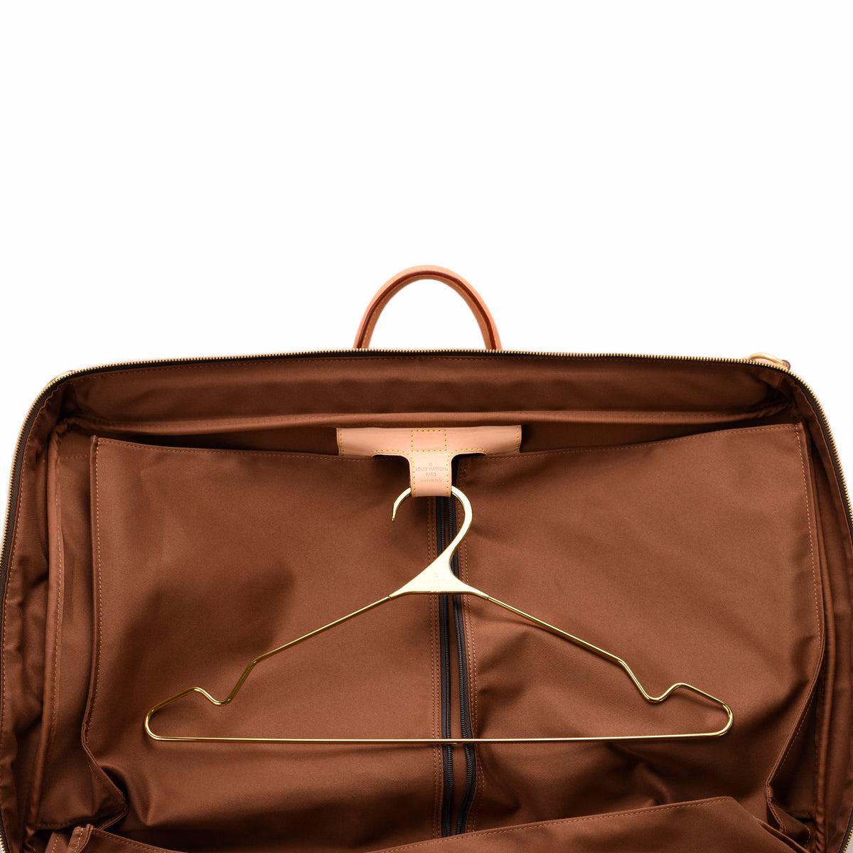 Brown fabric garment bag with a gold metal hanger, curated Pre-loved Luxury by Myluxe in Helsinki.