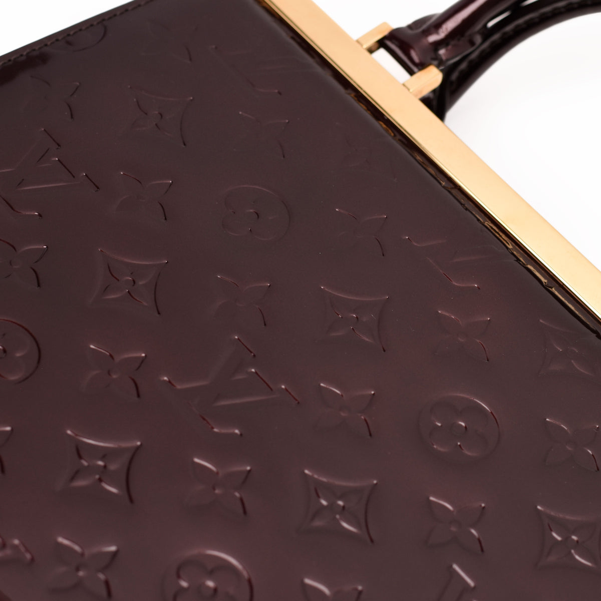 Embossed dark burgundy monogram leather Louis Vuitton handbag, curated Pre-loved Luxury by Myluxe in Helsinki.
