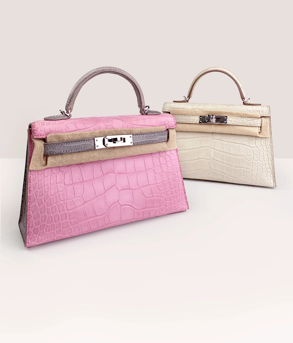 Pink crocodile leather top handle handbag and cream crocodile leather handbag, curated Pre-loved Luxury by Myluxe in Helsinki.