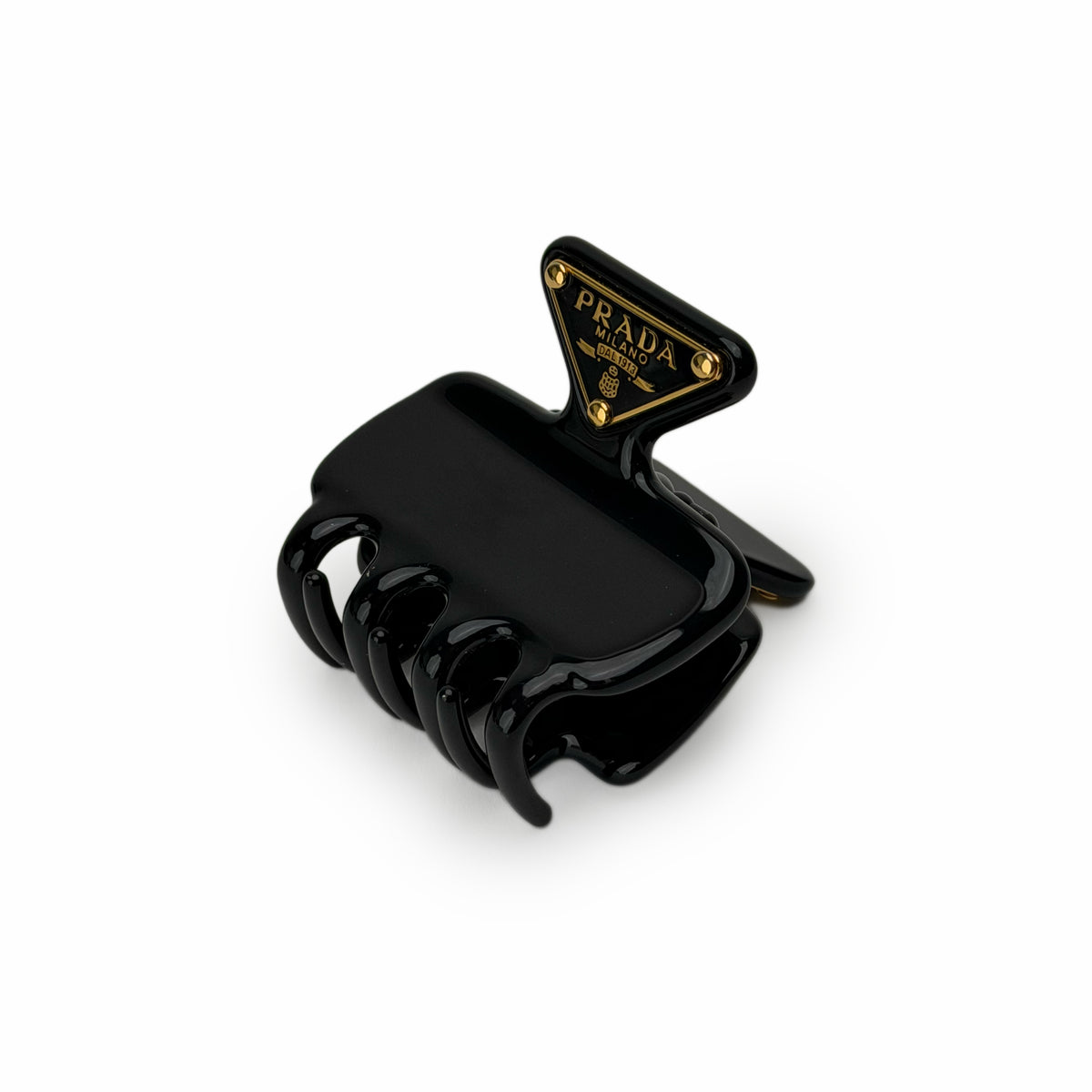 Black Prada hair claw clip with gold-tone logo detail, curated Pre-loved Luxury by Myluxe in Helsinki.