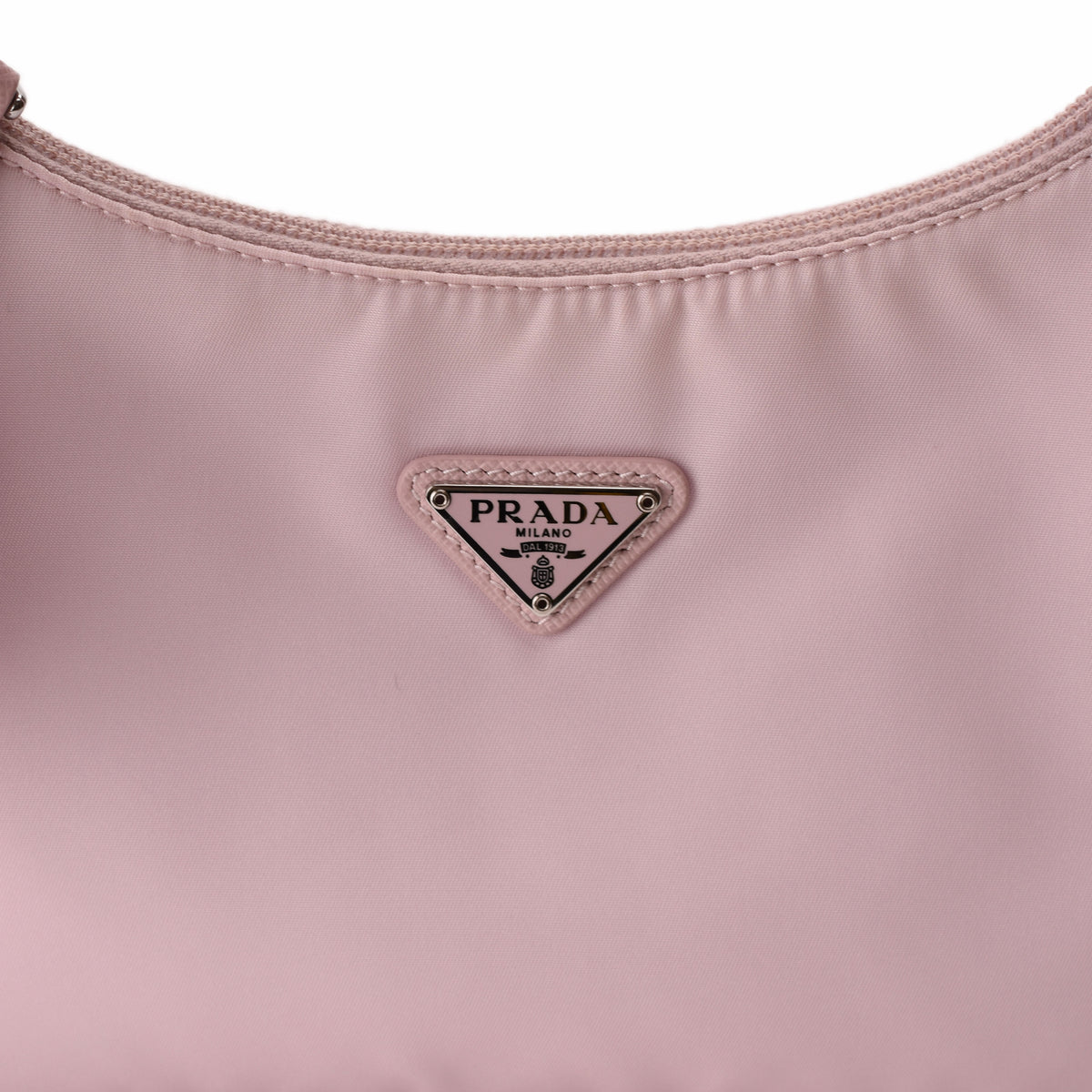 Prada pink nylon shoulder bag with silver triangle logo. curated Pre-loved Luxury by Myluxe in Helsinki.