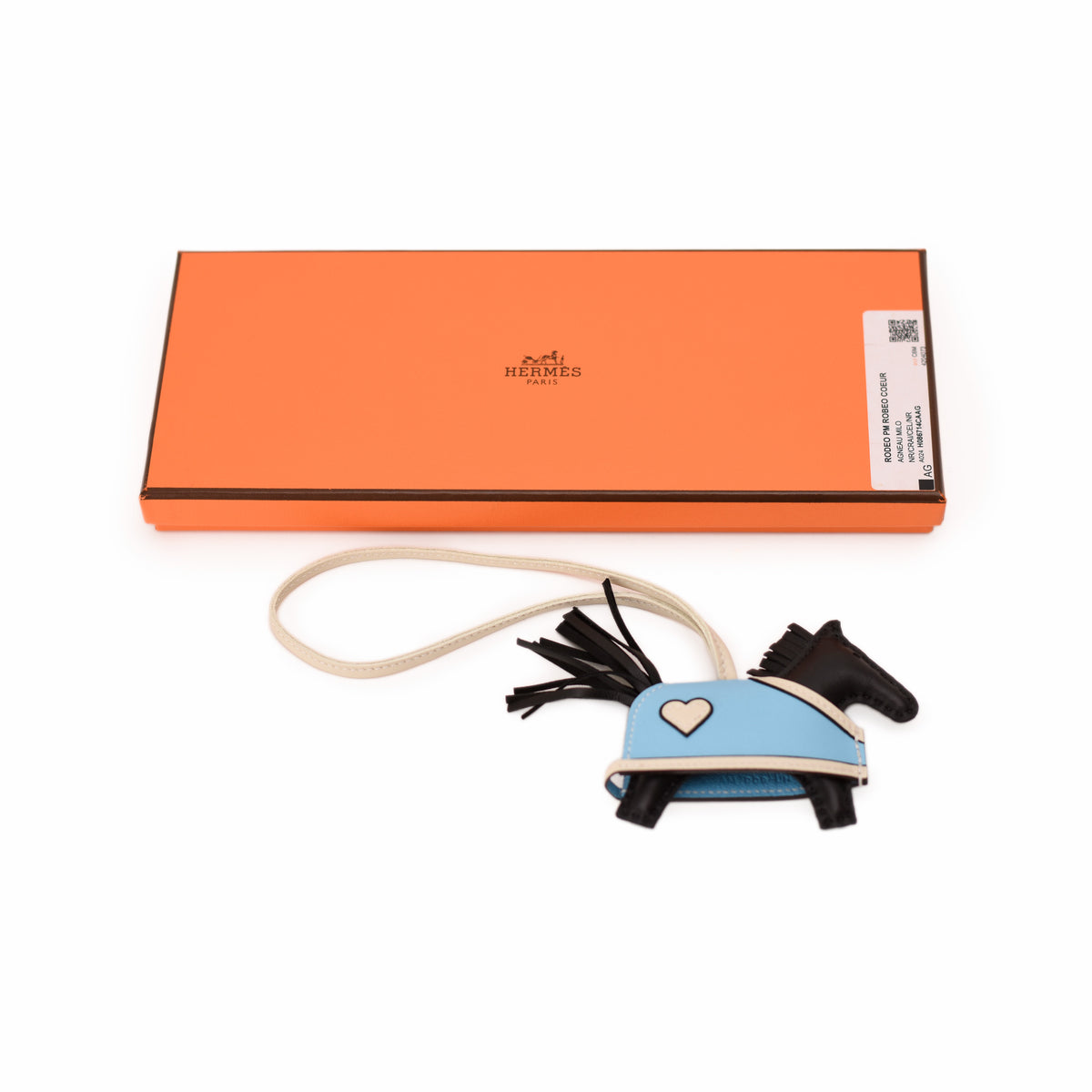 Hermès horse-shaped leather keychain in light blue and black. curated Pre-loved Luxury by Myluxe in Helsinki.