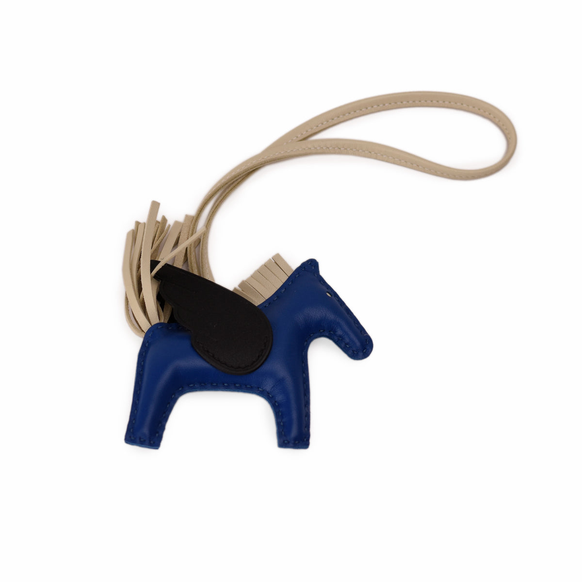Blue leather horse charm with tan tassel strap. Curated Pre-loved Luxury by Myluxe in Helsinki.