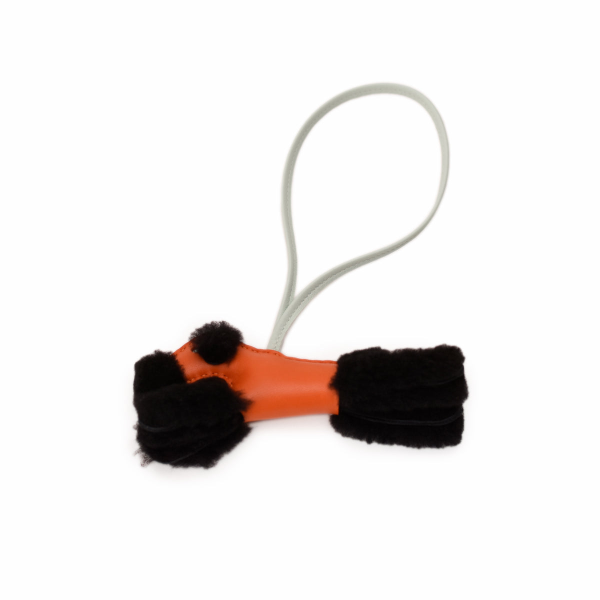Orange leather bag charm with black faux fur accents and a grey strap, curated Pre-loved Luxury by Myluxe in Helsinki.