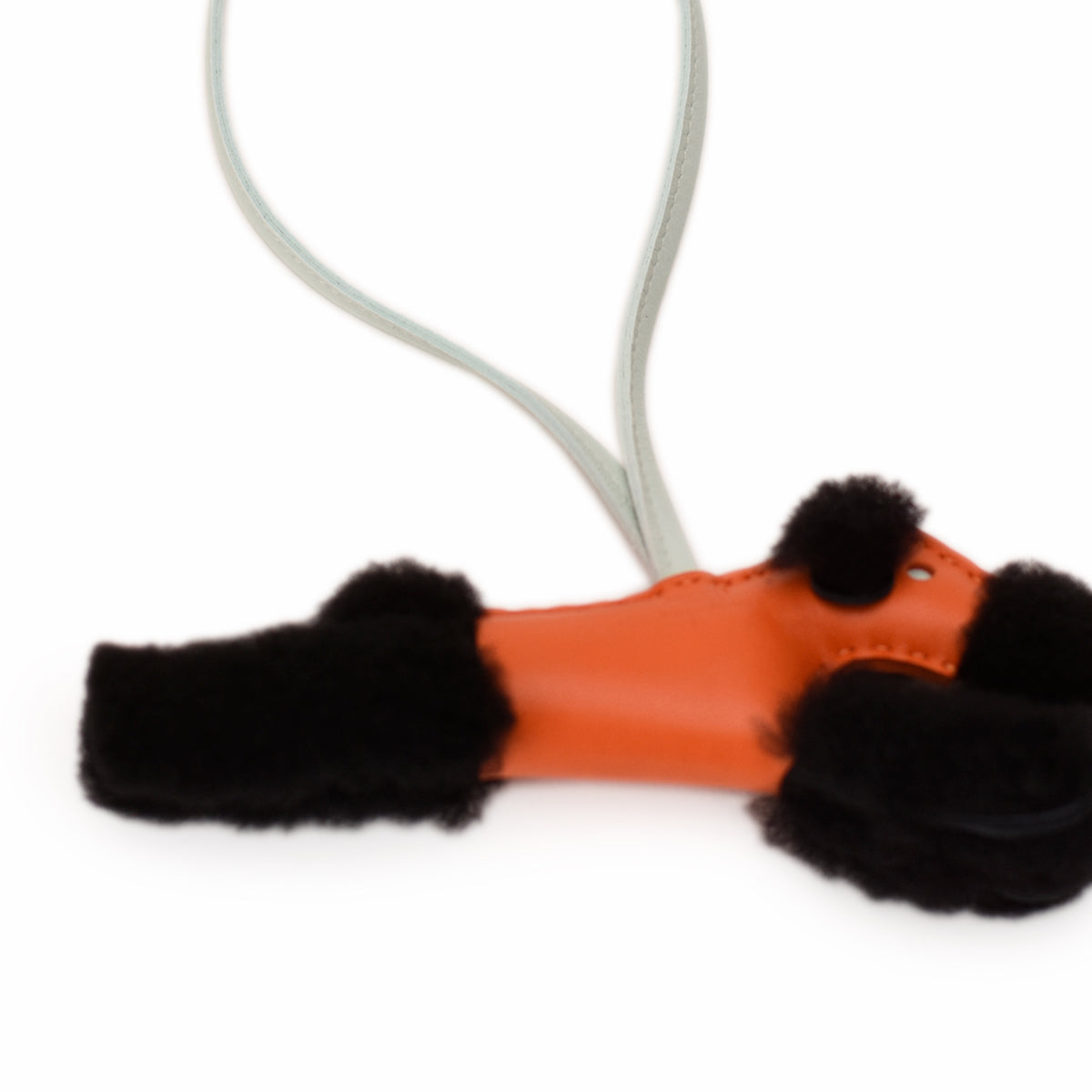 Orange leather accessory with black faux fur trim, curated Pre-loved Luxury by Myluxe in Helsinki.