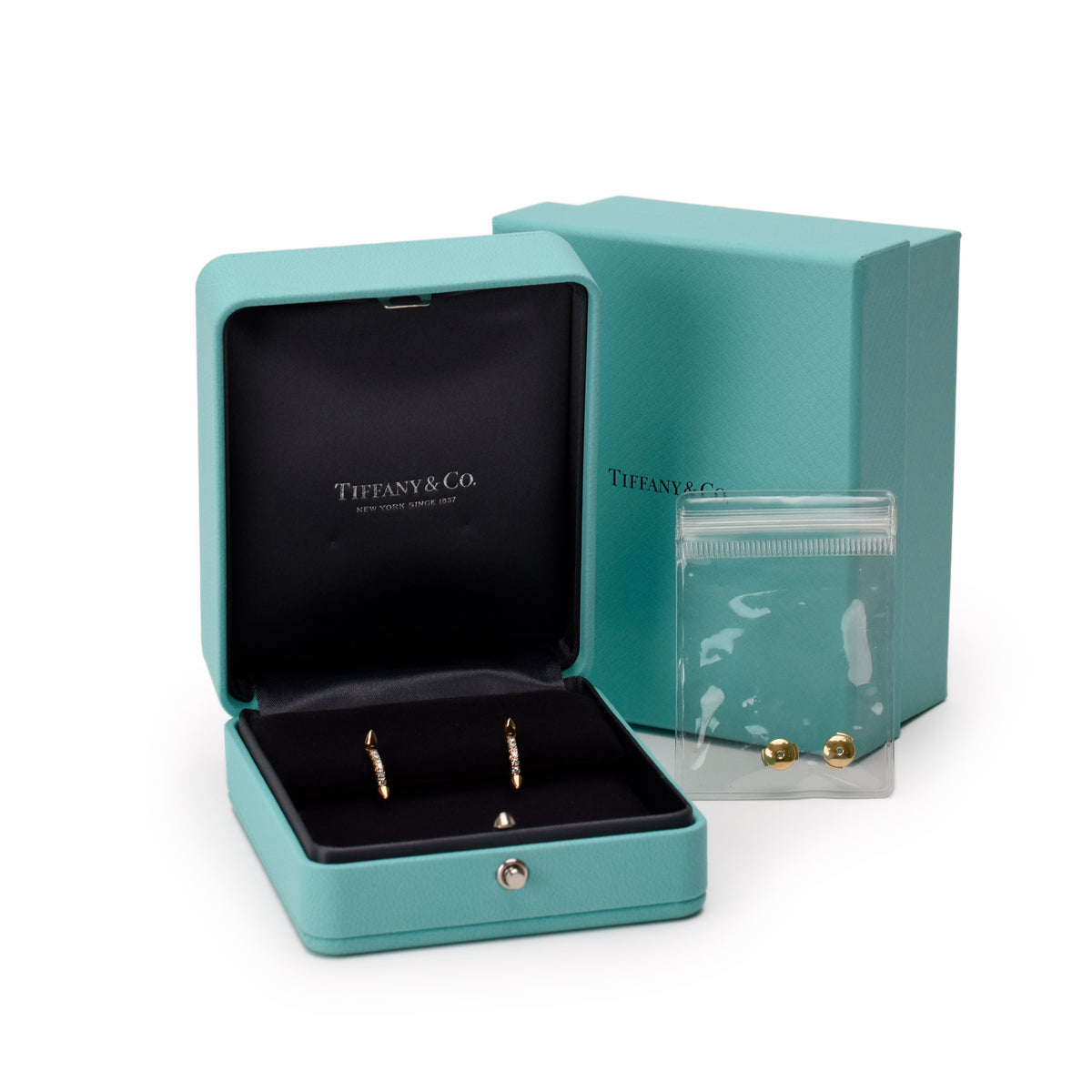 Tiffany & Co. gold stud earrings in a signature turquoise blue box, curated Pre-loved Luxury by Myluxe in Helsinki.