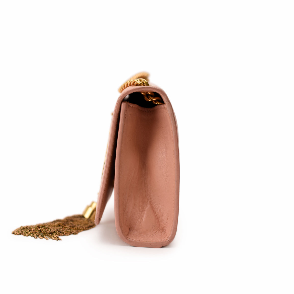 Side view of a mauve leather Chanel handbag with gold chain strap and tassel, curated Pre-loved Luxury by Myluxe in Helsinki.