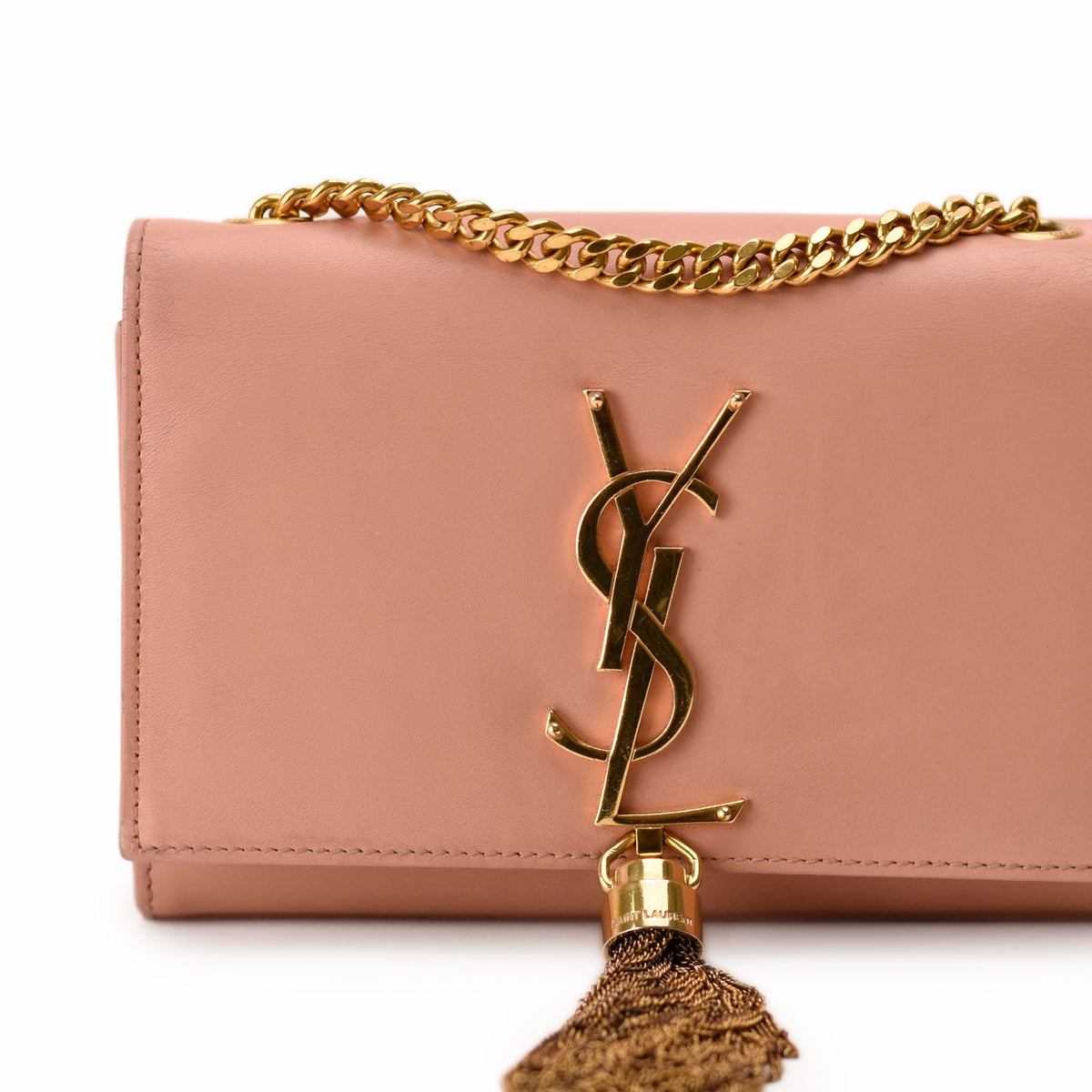 Blush pink leather Saint Laurent handbag with gold YSL logo and tassel, curated Pre-loved Luxury by Myluxe in Helsinki.