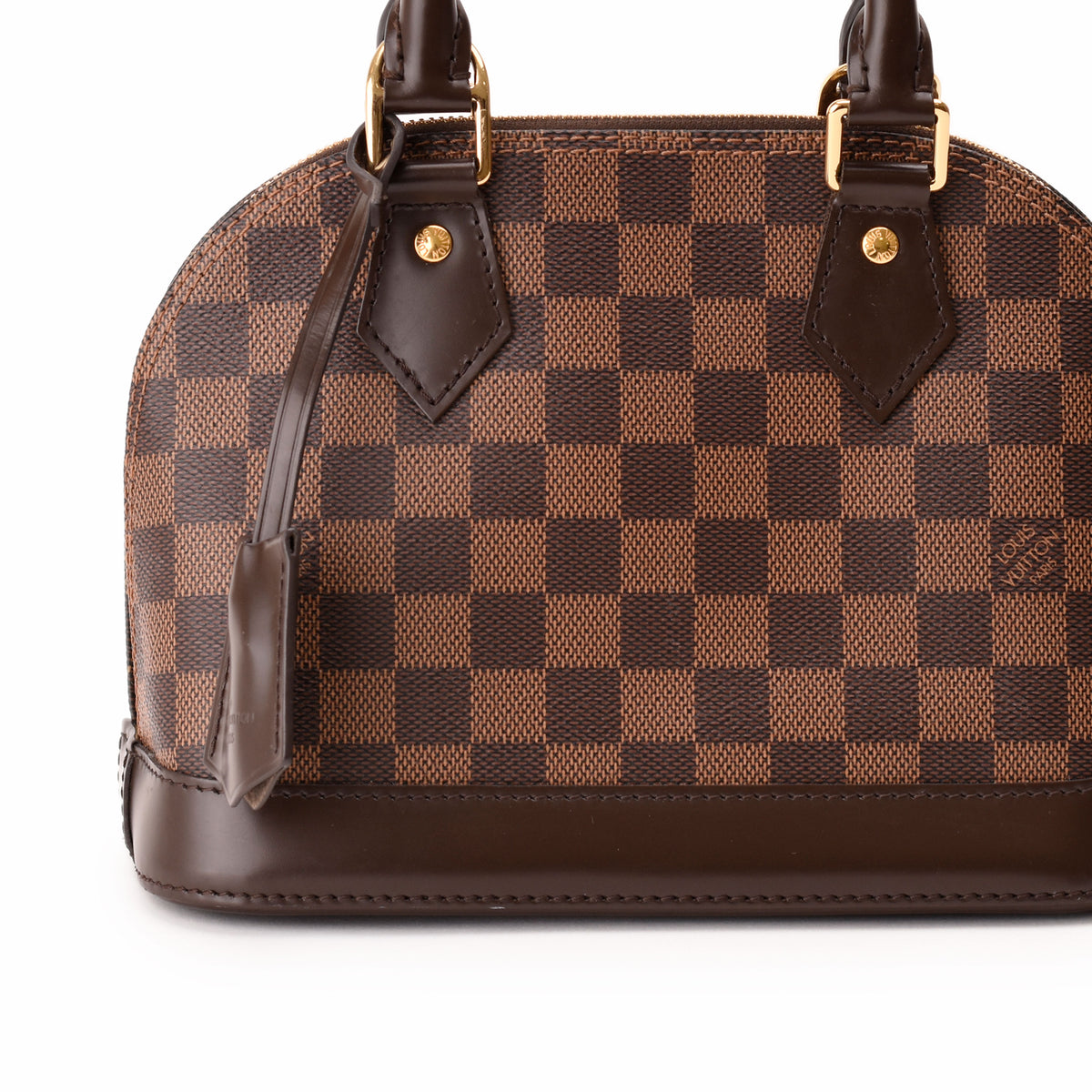 Louis Vuitton Damier Ebene checkered canvas handbag with brown leather trim. curated Pre-loved Luxury by Myluxe in Helsinki.
