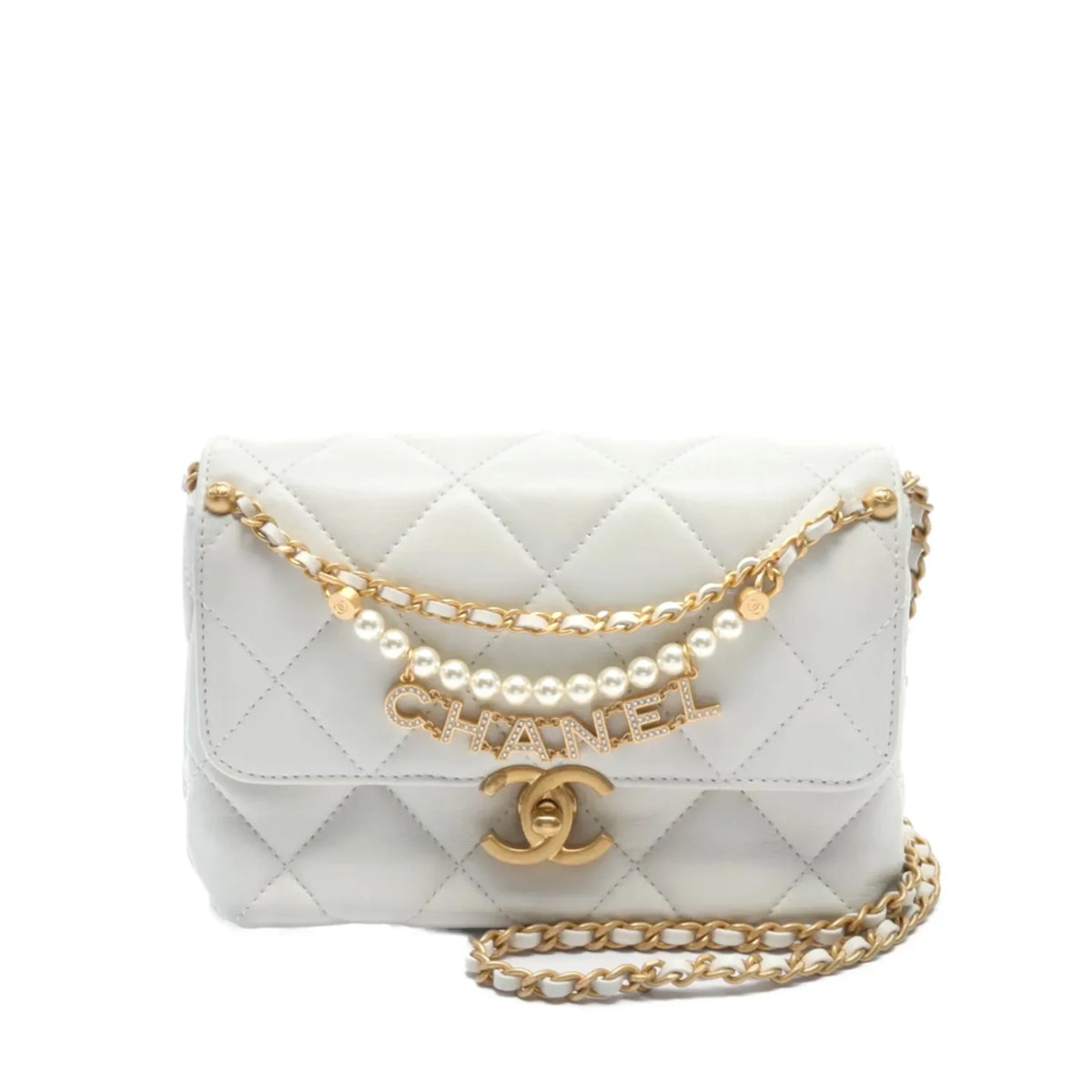 Chanel Mini Flap Bag in white leather with pearl embellishments and gold hardware, showcasing a compact elegant design.