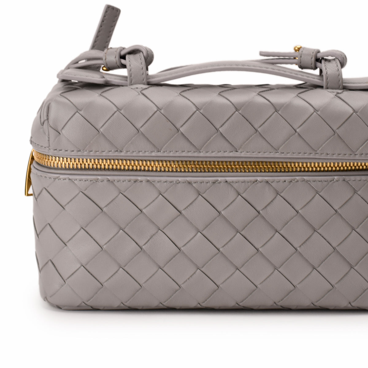 Grey woven leather Bottega Veneta cosmetic pouch with gold-tone zipper, curated Pre-loved Luxury by Myluxe in Helsinki.
