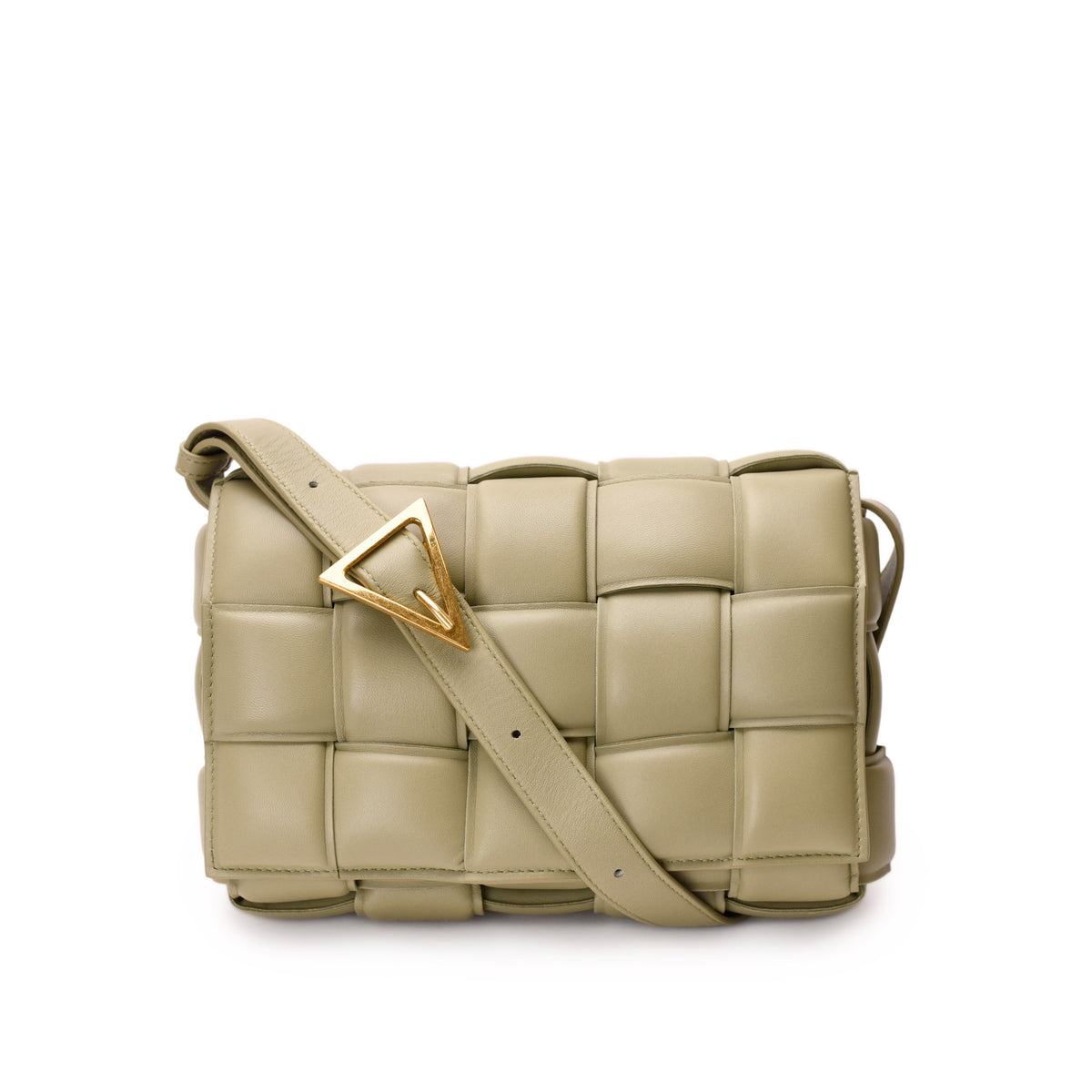 Bottega Veneta padded Cassette bag in sage lambskin with signature woven design and sleek rectangular shape.