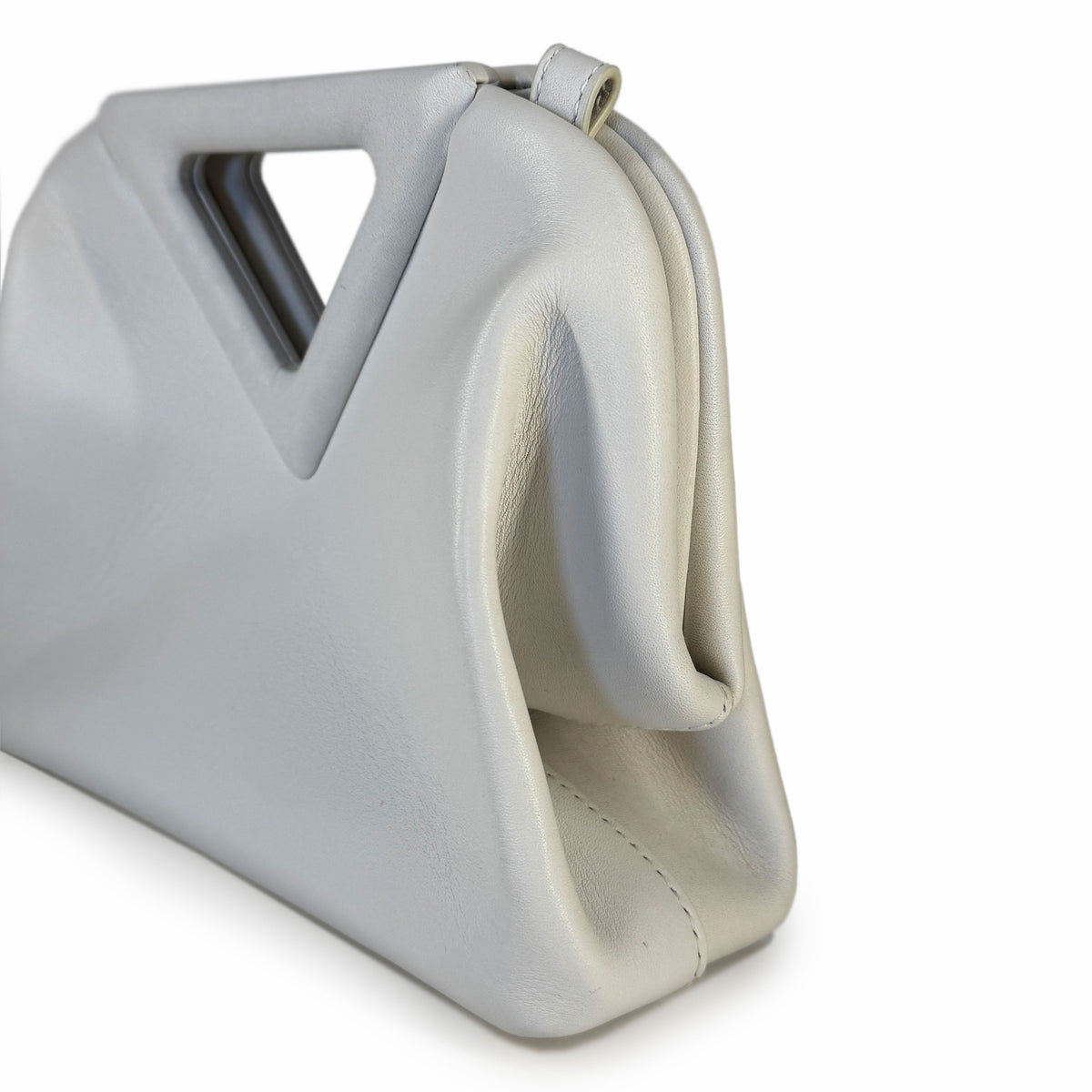 Light grey soft leather designer handbag with sculptural handle, curated Pre-loved Luxury by Myluxe in Helsinki.