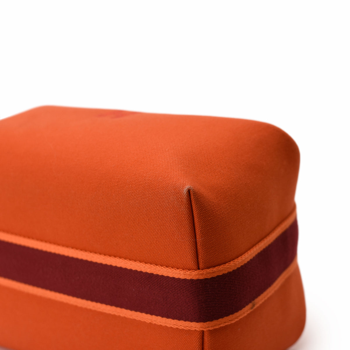 Orange fabric luxury accessory box with a dark red ribbon band. curated Pre-loved Luxury by Myluxe in Helsinki.