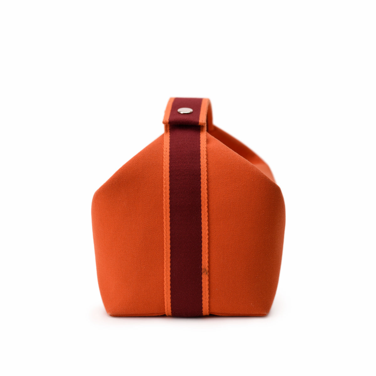 Orange canvas Hermès bag with a vertical burgundy stripe. curated Pre-loved Luxury by Myluxe in Helsinki.