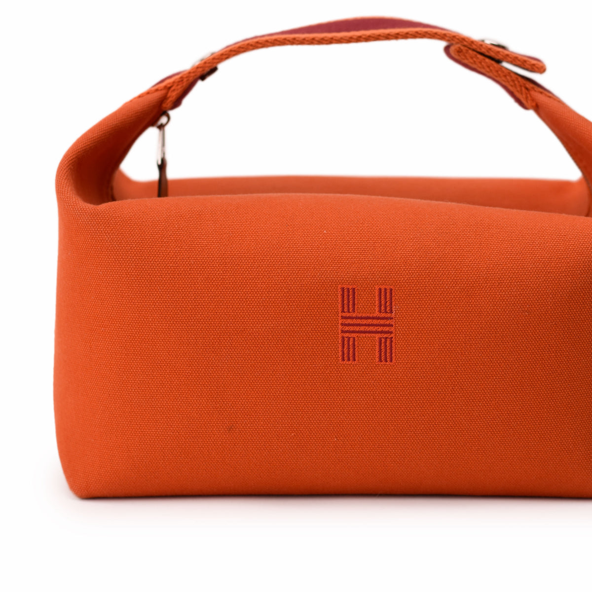 Orange canvas Hermès handbag with signature H logo. curated Pre-loved Luxury by Myluxe in Helsinki.