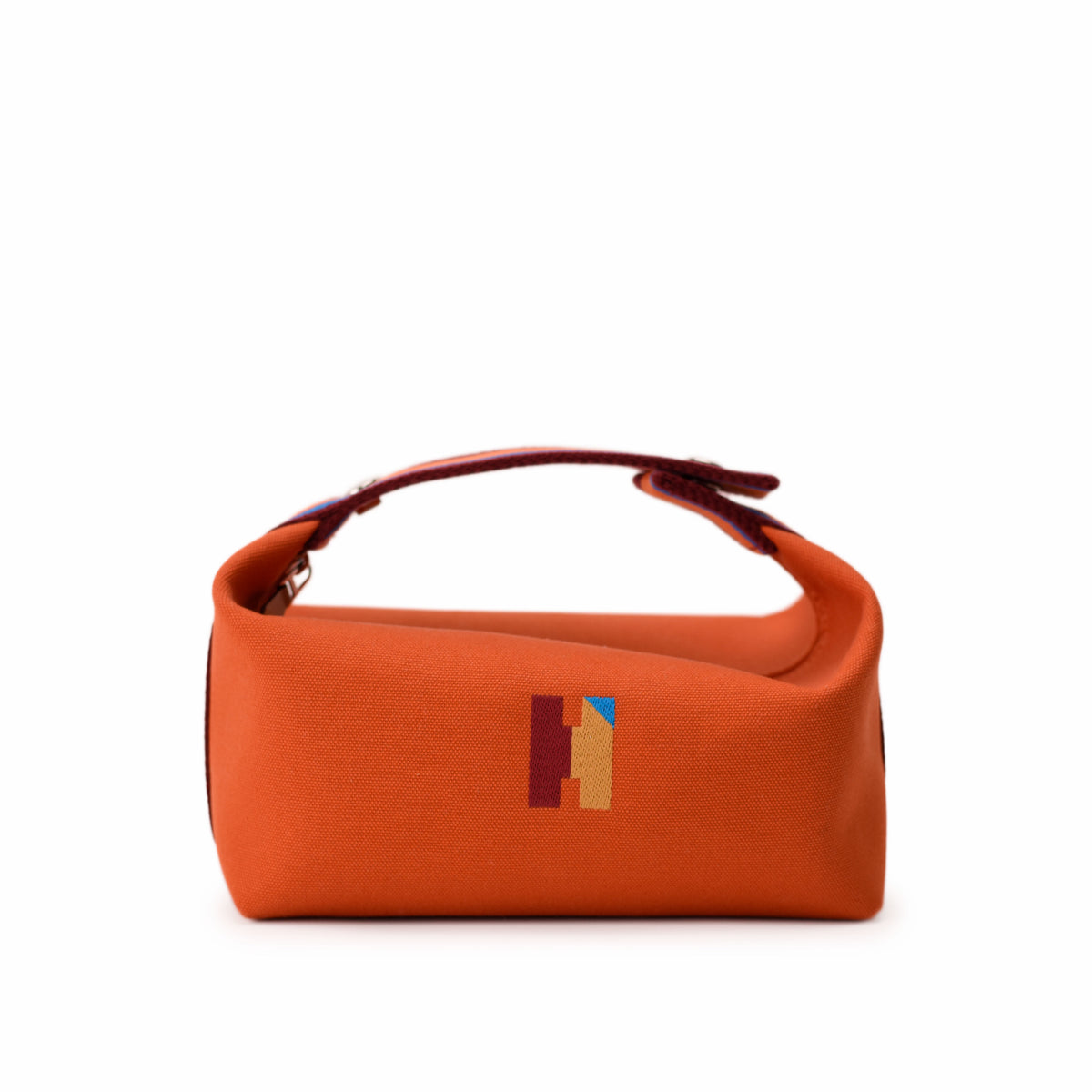 Orange canvas handbag with geometric pattern detail. curated Pre-loved Luxury by Myluxe in Helsinki.