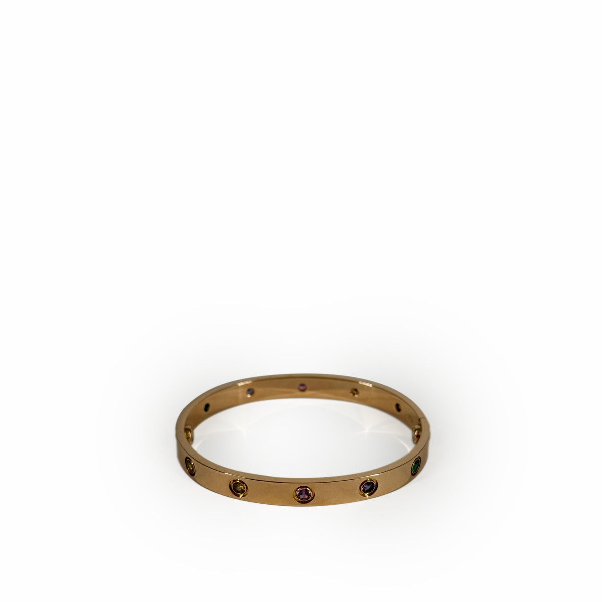 Gold-tone metal bangle featuring inlaid multi-colored gemstones, curated Pre-loved Luxury by Myluxe in Helsinki.