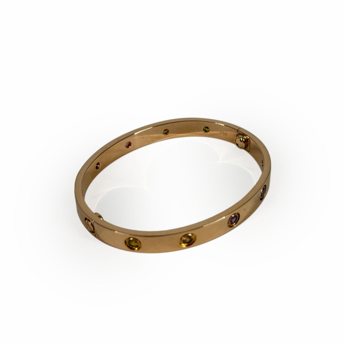 Gold-tone bangle bracelet featuring inlaid multi-colored gemstones, curated Pre-loved Luxury by Myluxe in Helsinki.