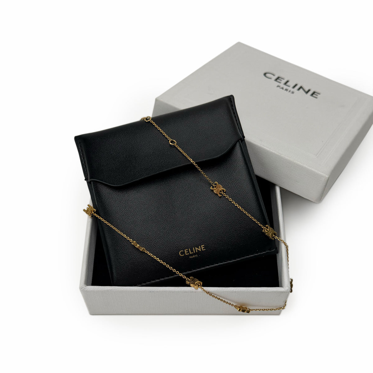 Black grained leather Celine pouch with a gold-tone chain, curated Pre-loved Luxury by Myluxe in Helsinki.