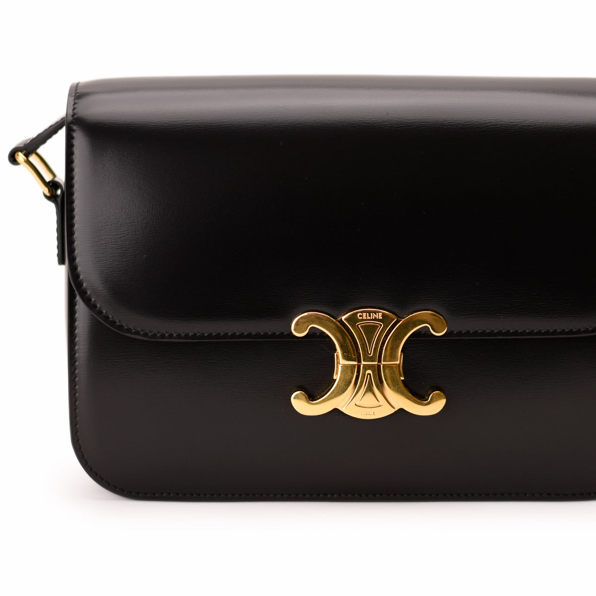 Black smooth leather Celine Triomphe handbag with gold-tone metal clasp. curated Pre-loved Luxury by Myluxe in Helsinki.