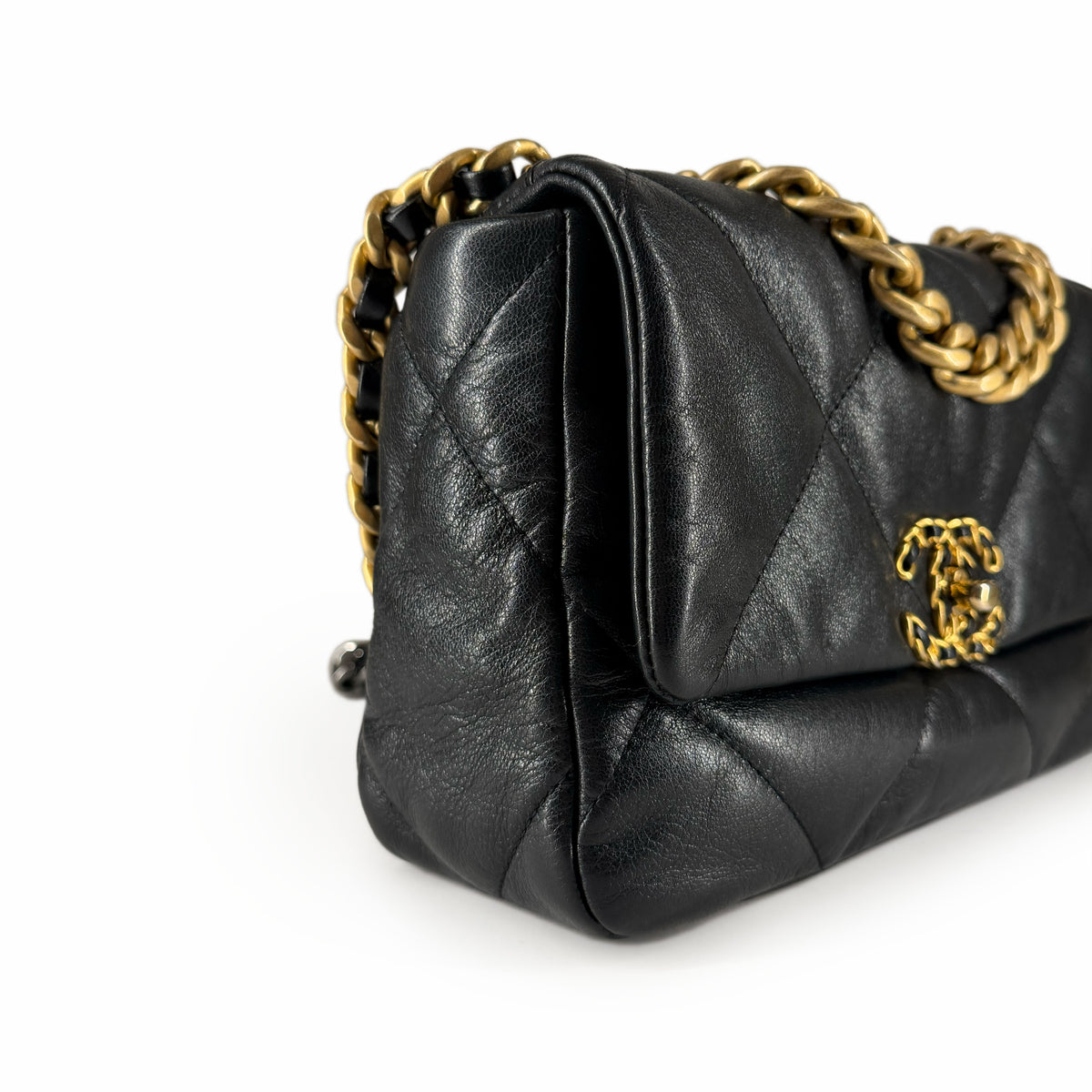 Black quilted lambskin Chanel handbag with gold-tone chain strap, curated Pre-loved Luxury by Myluxe in Helsinki.