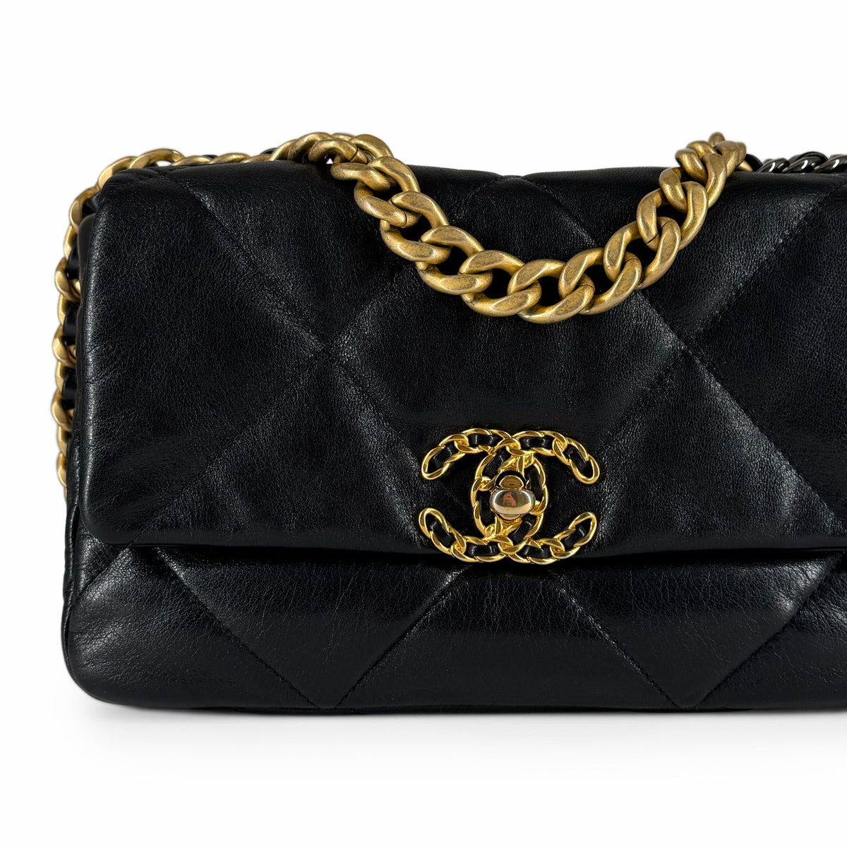 Black quilted lambskin Chanel flap bag with gold-tone chain hardware, curated Pre-loved Luxury by Myluxe in Helsinki.