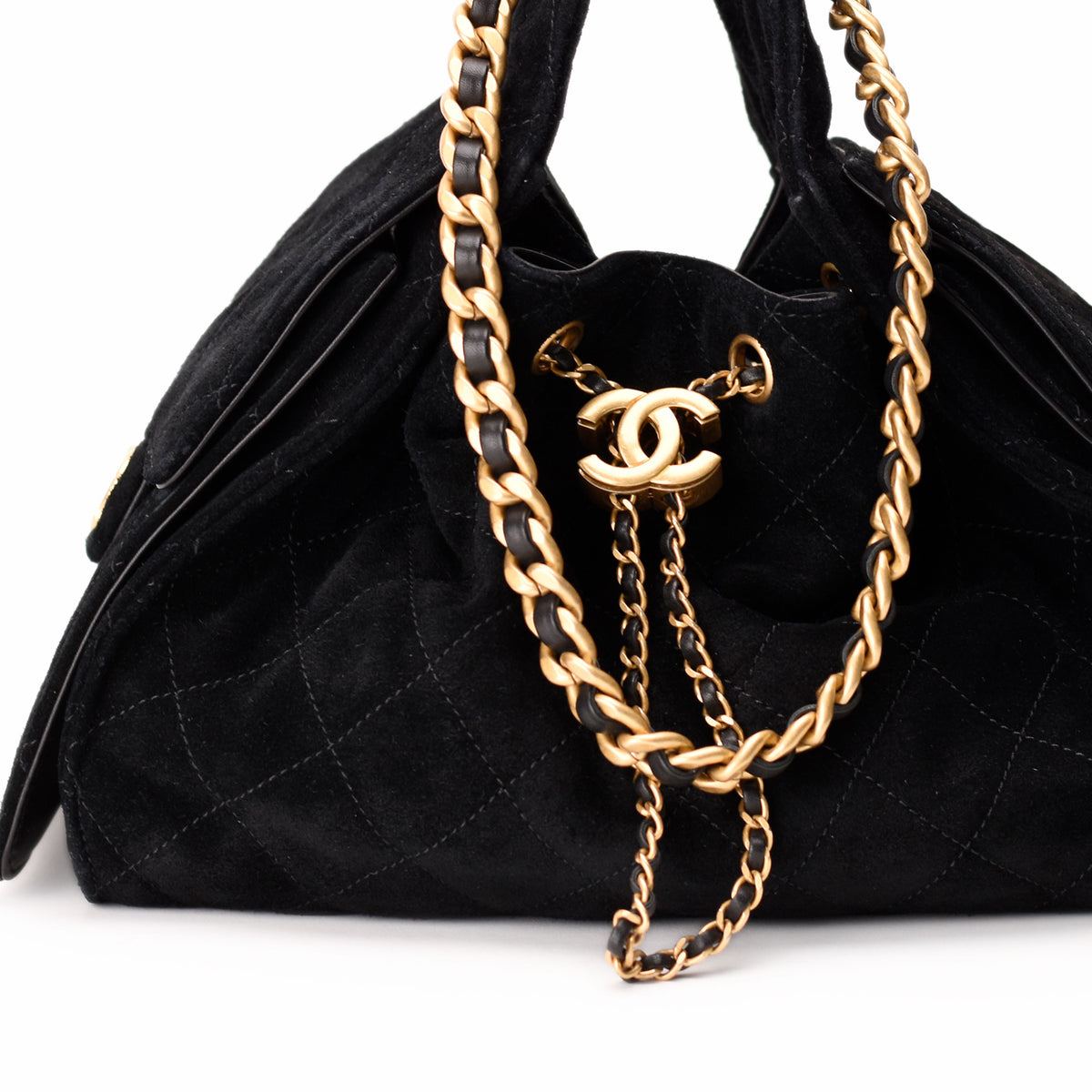 Black quilted suede Chanel handbag with gold chain strap, curated Pre-loved Luxury by Myluxe in Helsinki.